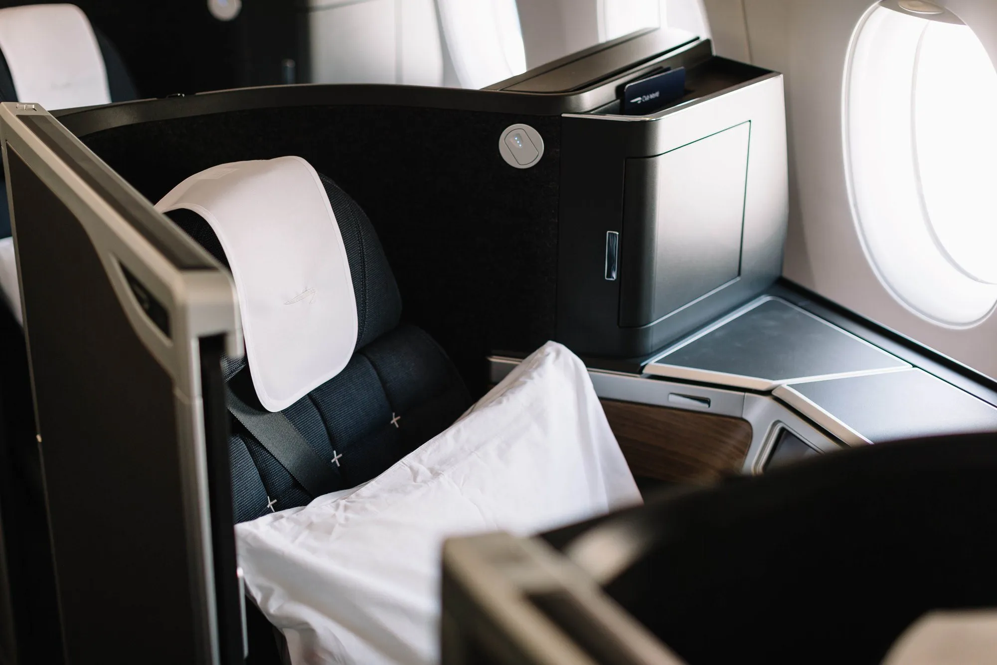 A BA Club Suite on an A350, seen from the aisle, with its door and window