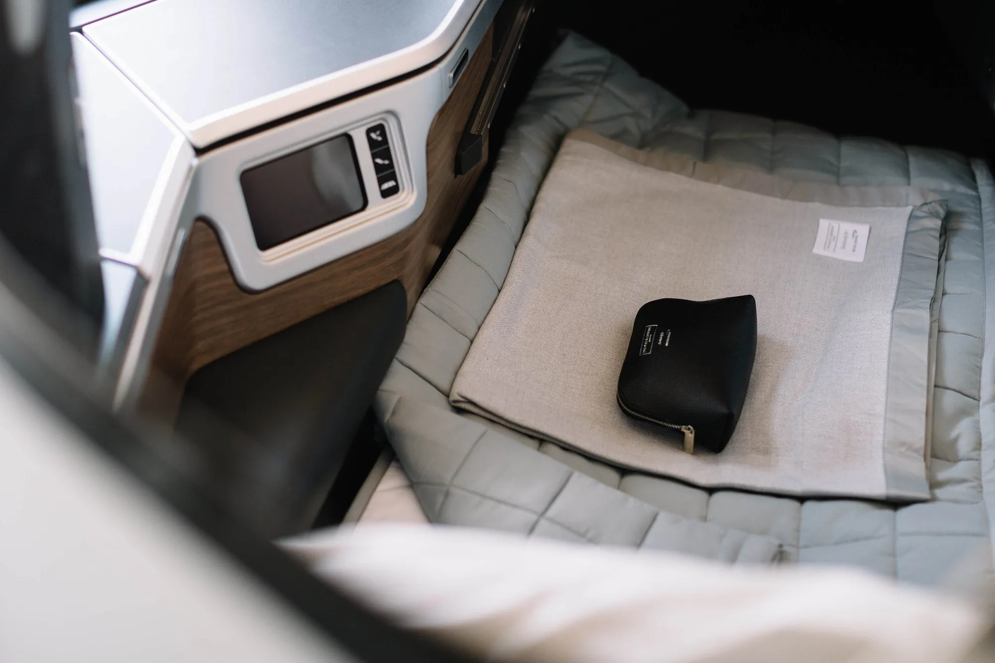 A Club Suite made up as a flat bed with a duvet and amenity kit