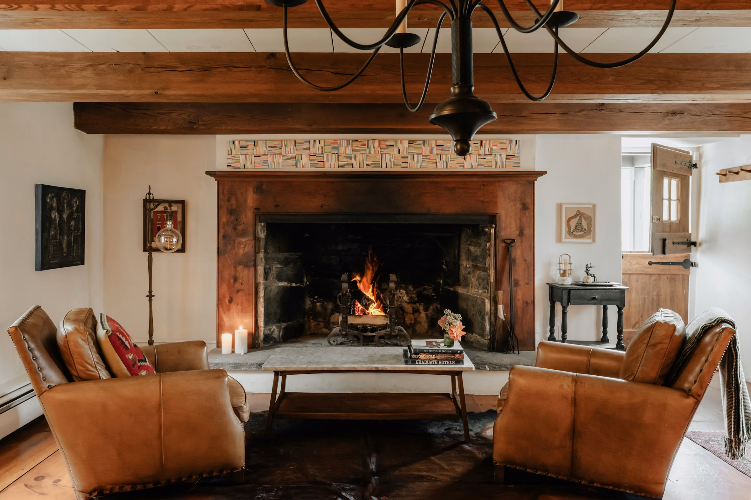 Leather armchairs by a big fireplace in a lodge-style lounge