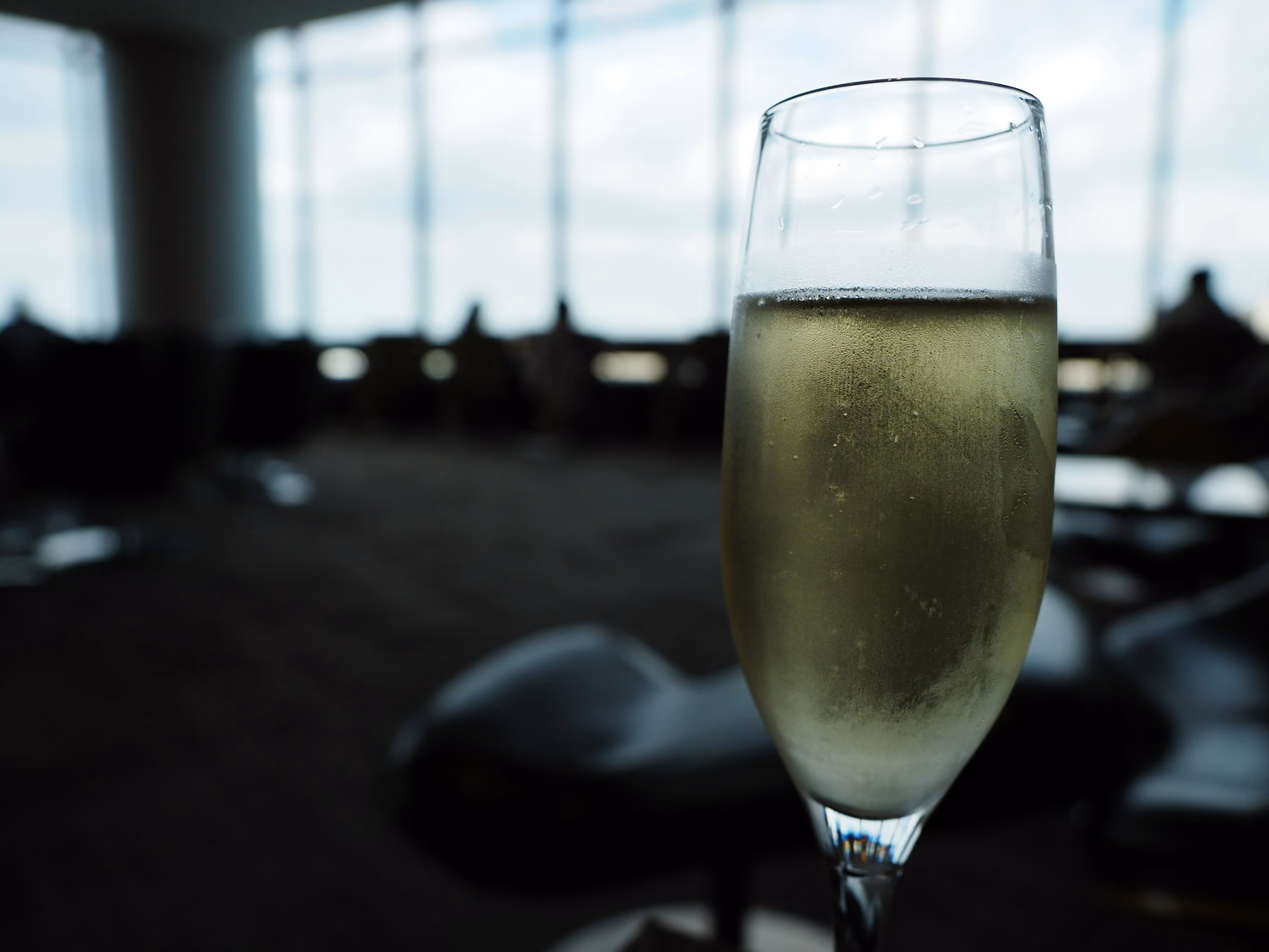 A glass of Champagne by an aircraft window