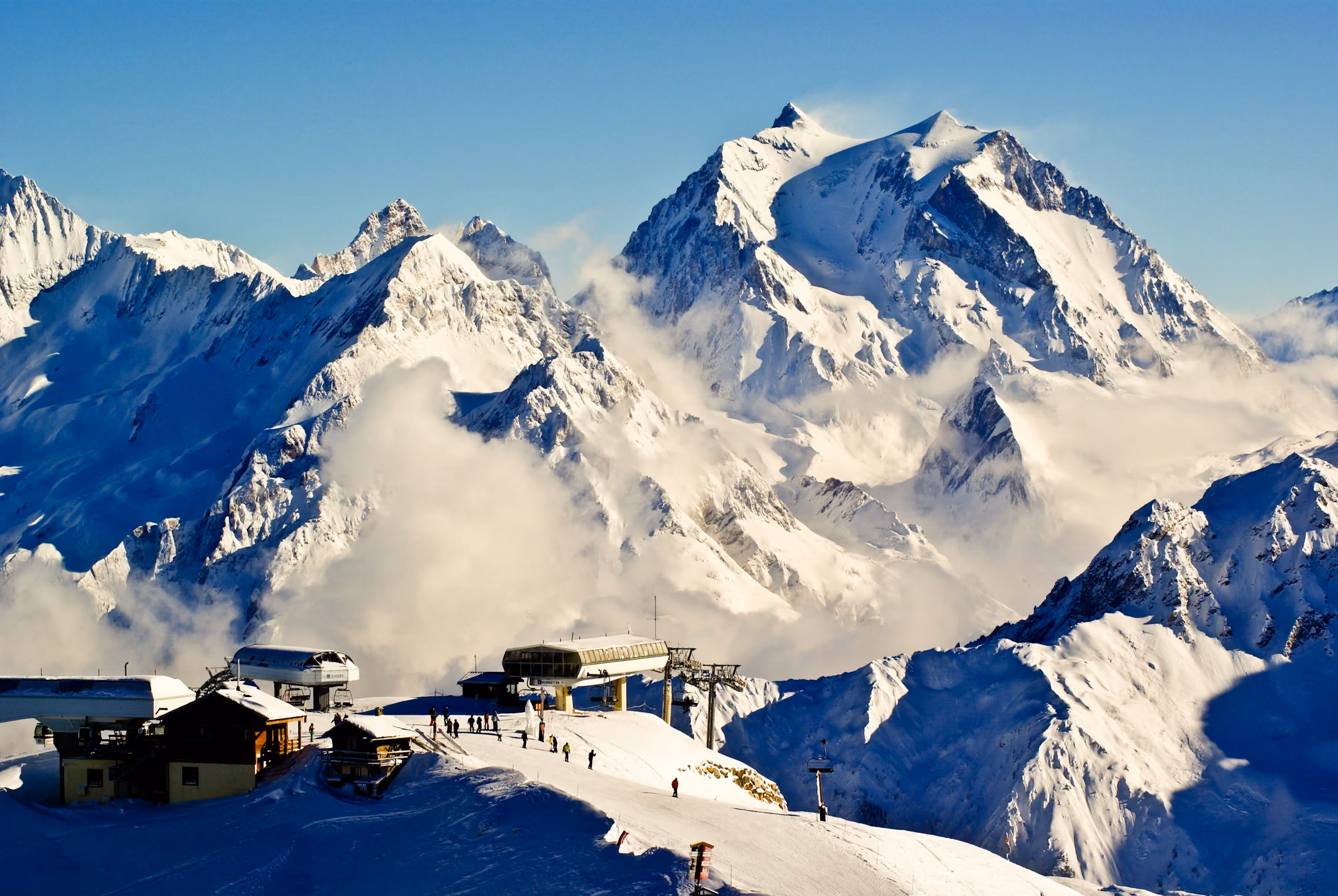 Snow-covered peaks above Courchevel's ski lifts
