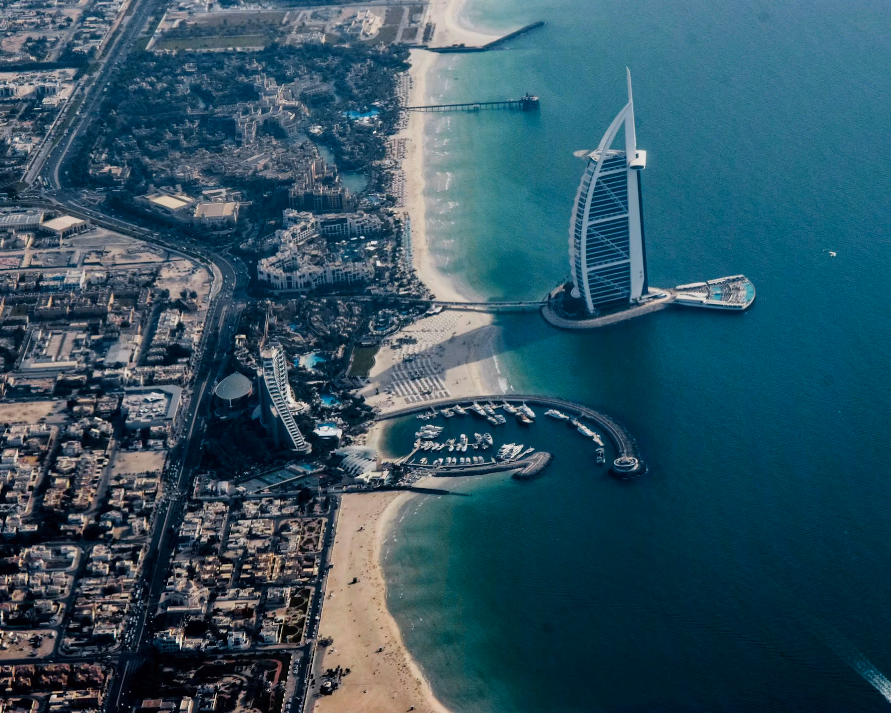 The Burj Al Arab and Jumeirah coastline seen from the air, the best time to visit Dubai being the cooler winter months