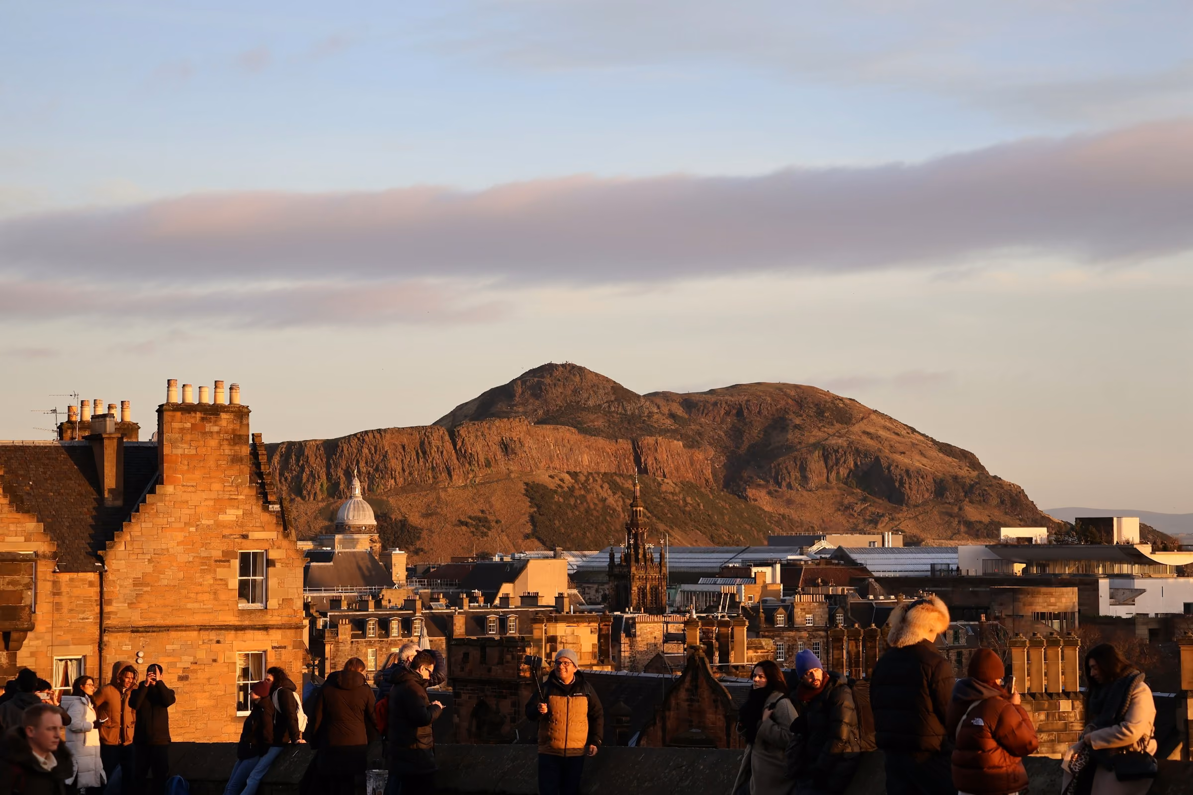 Arthur's Seat glowing at dusk above Edinburgh's rooftops