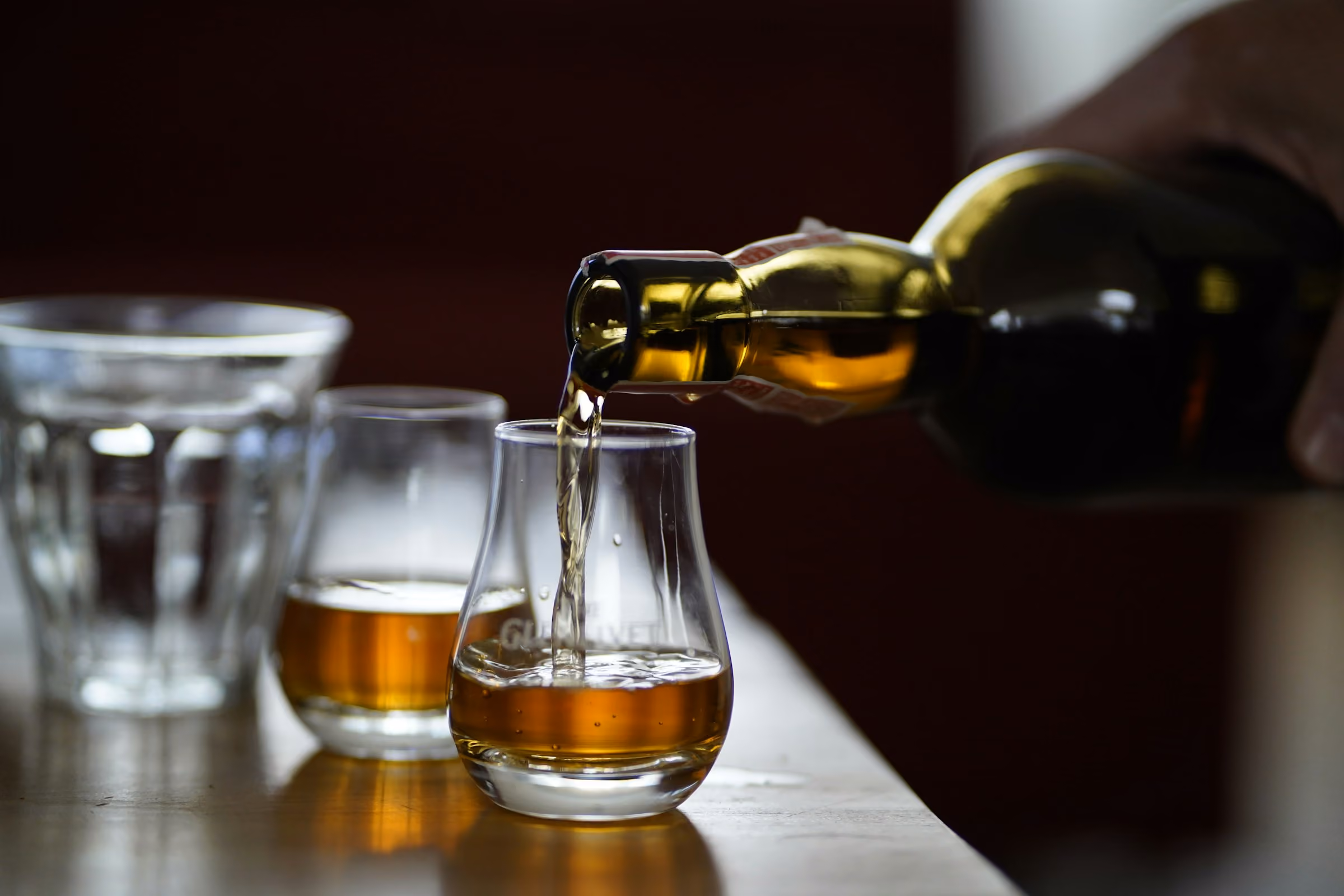 Whisky being poured into tasting glasses at an Edinburgh tasting