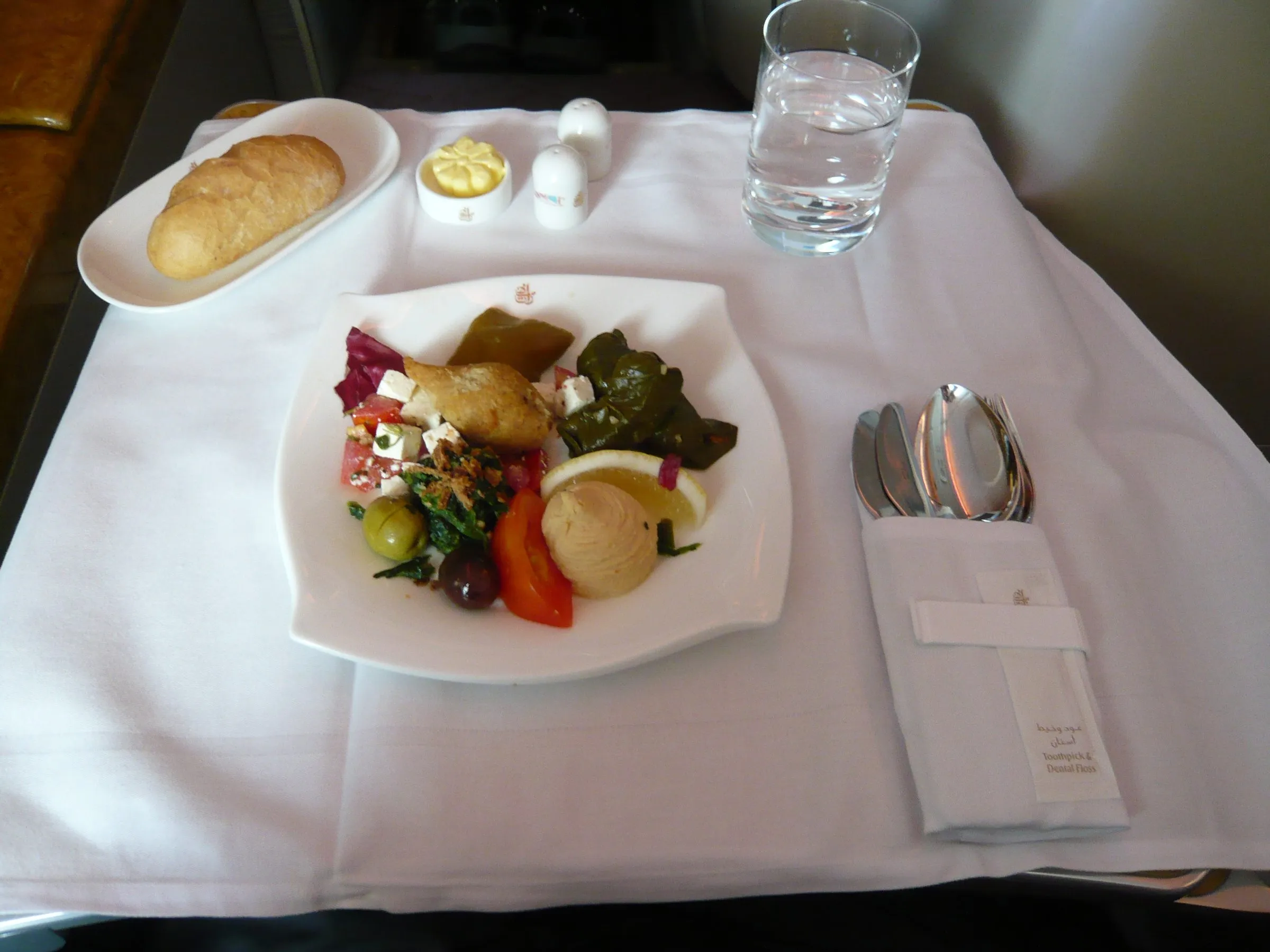 Dinner served on a white tablecloth in Emirates business class