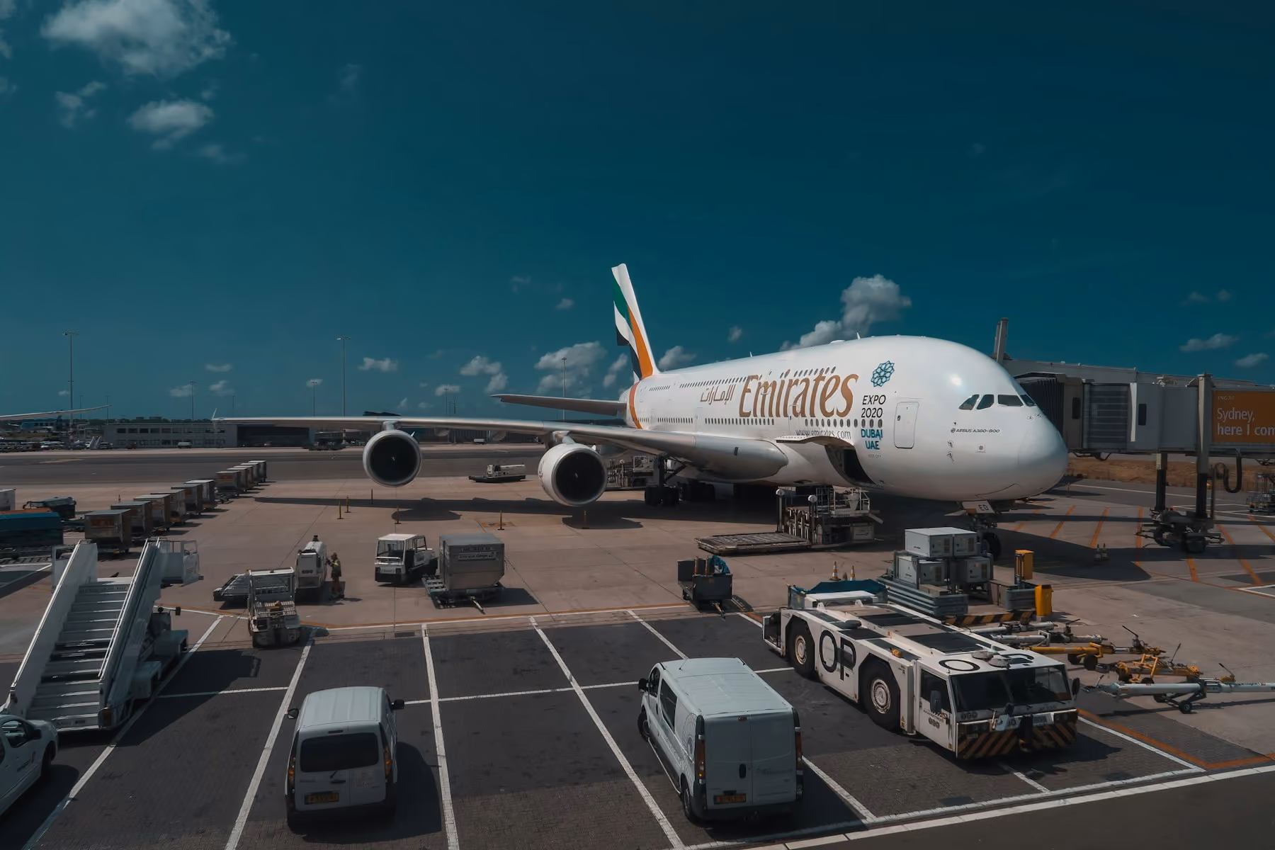 An Emirates A380 parked at an airport stand