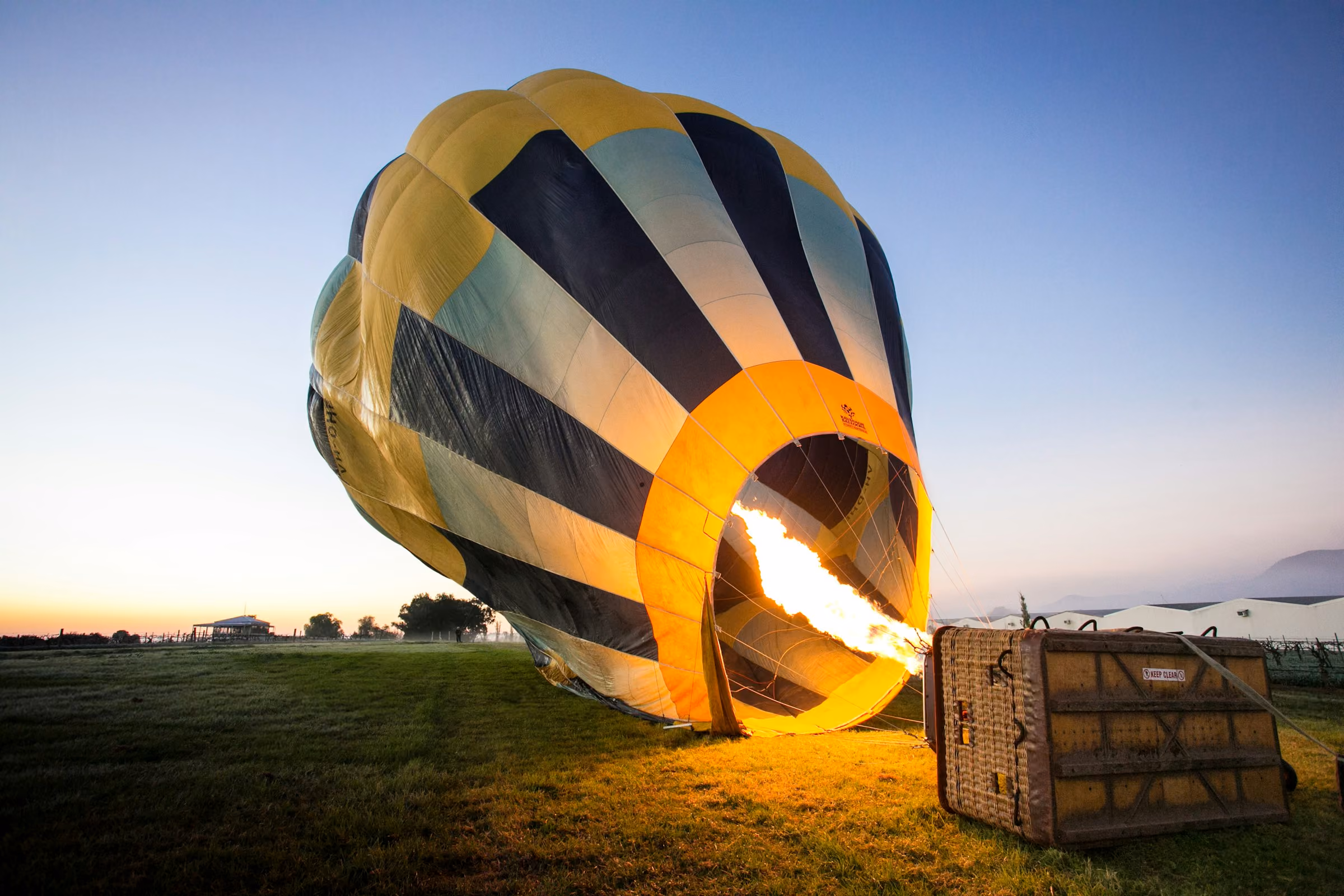A hot air balloon being inflated at dawn
