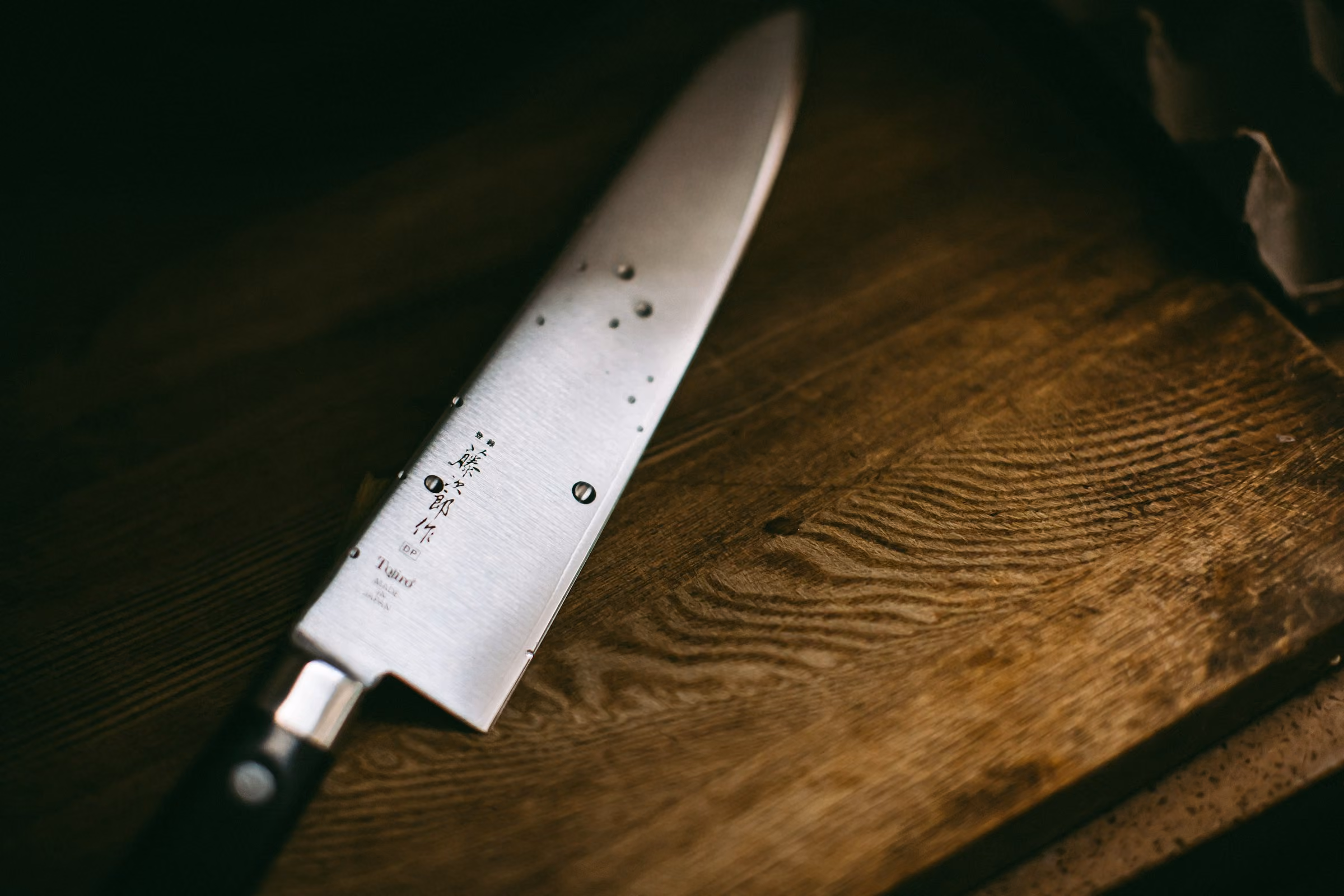 A chef's knife on a wooden board
