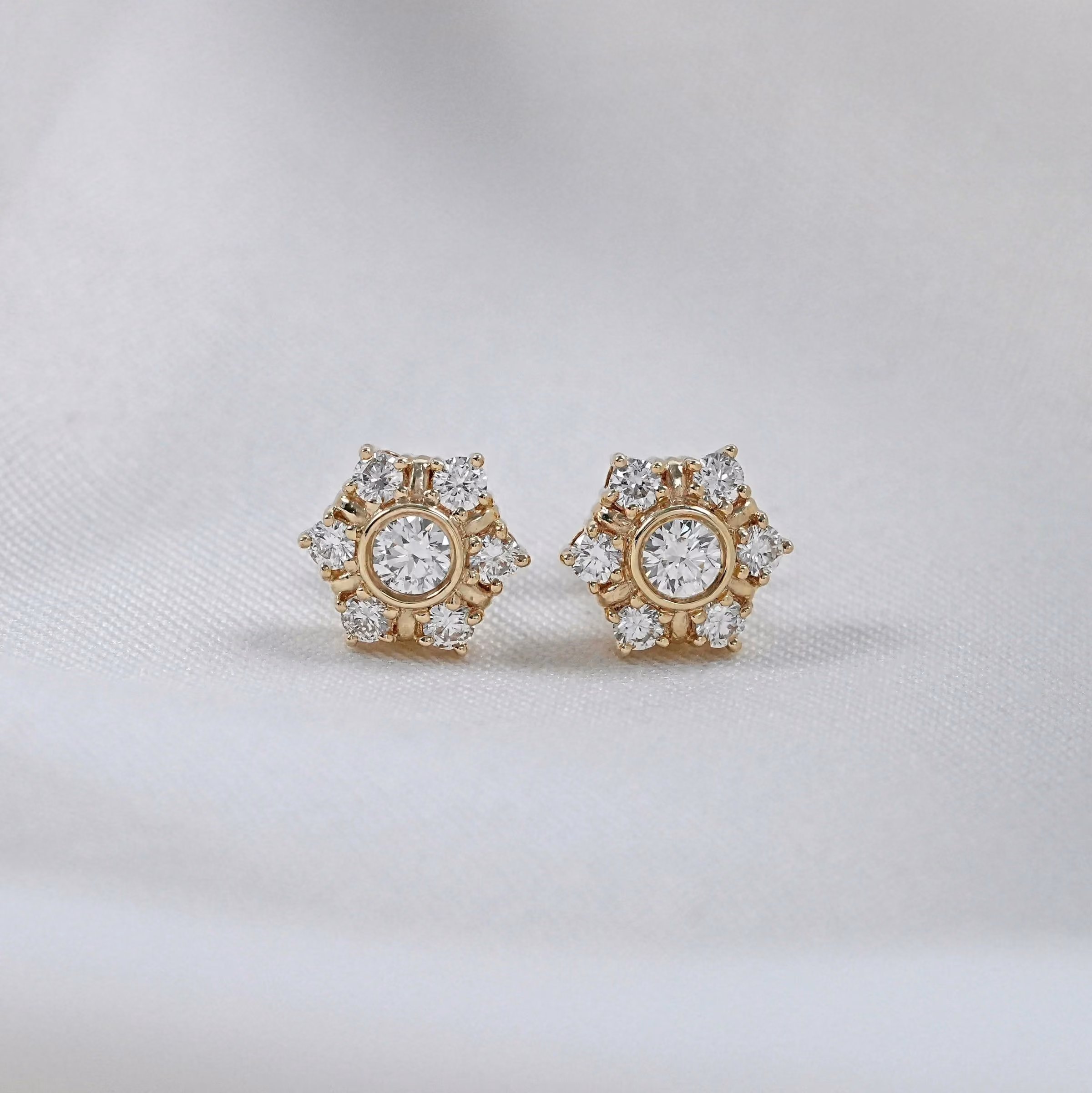 Diamond stud earrings in a gold flower setting