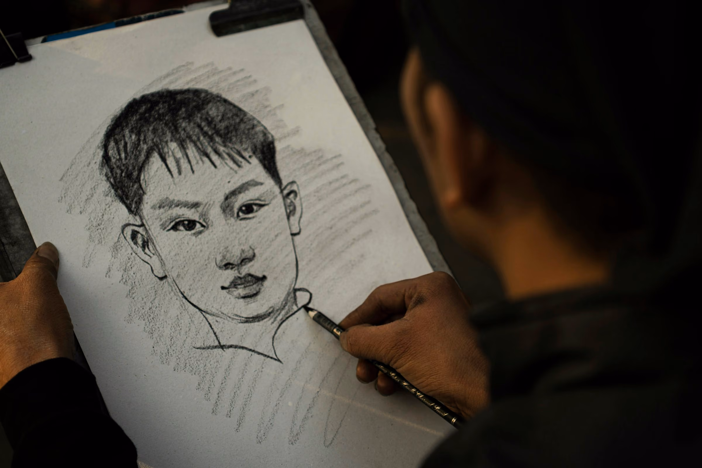 A pencil portrait sketch on a pad