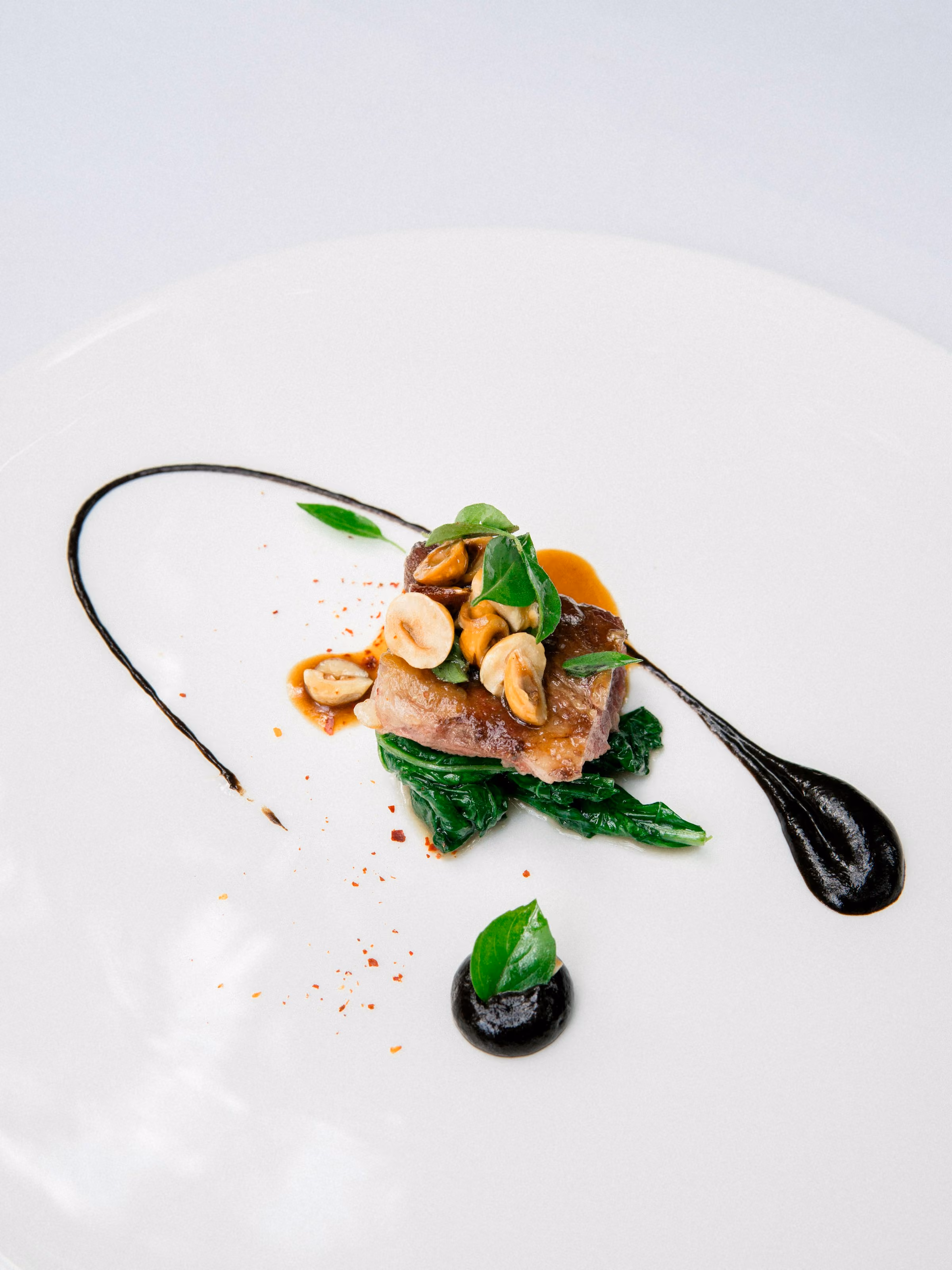 A small tasting-menu course on a white plate