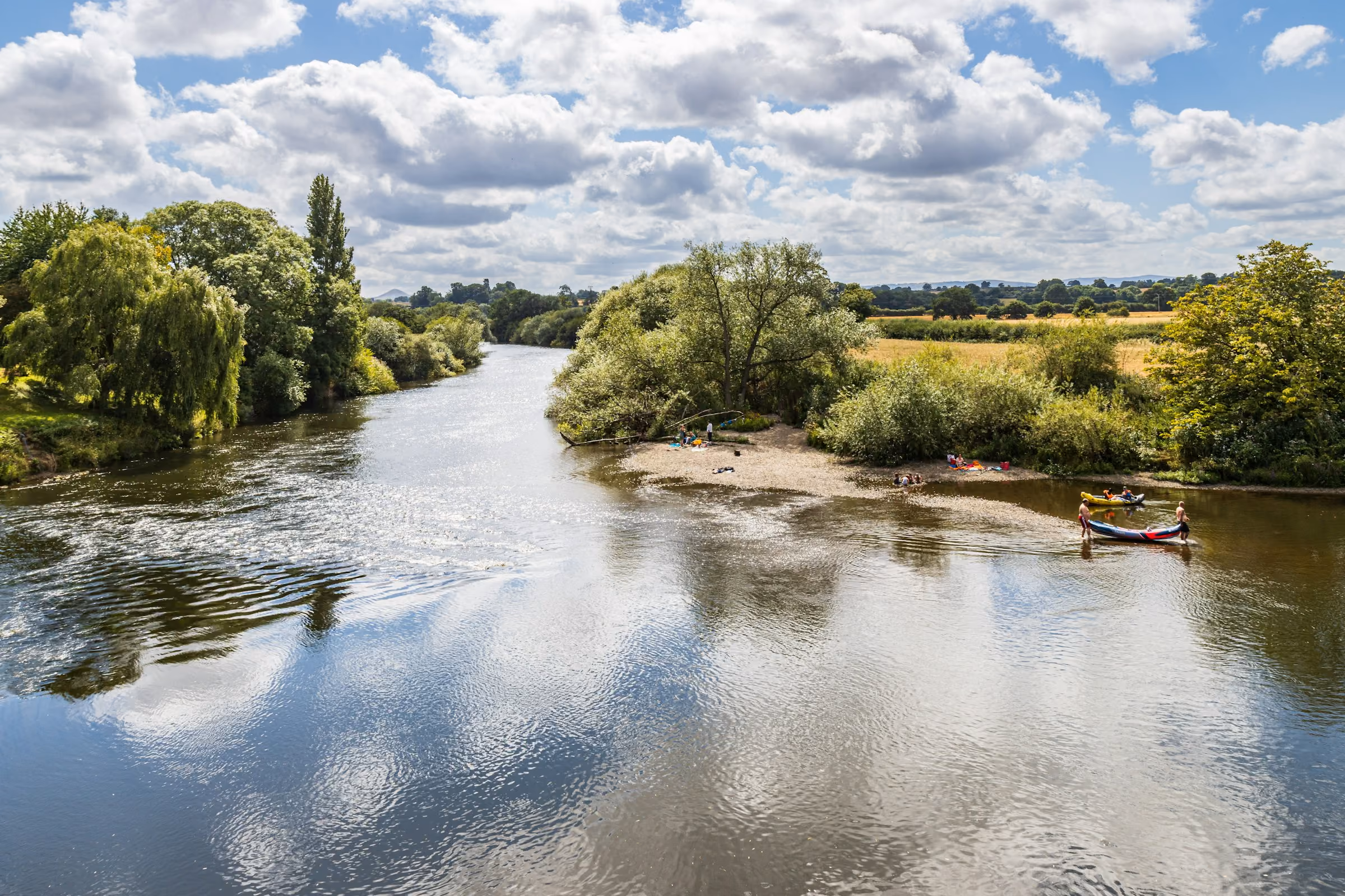 A wide English river under a summer sky