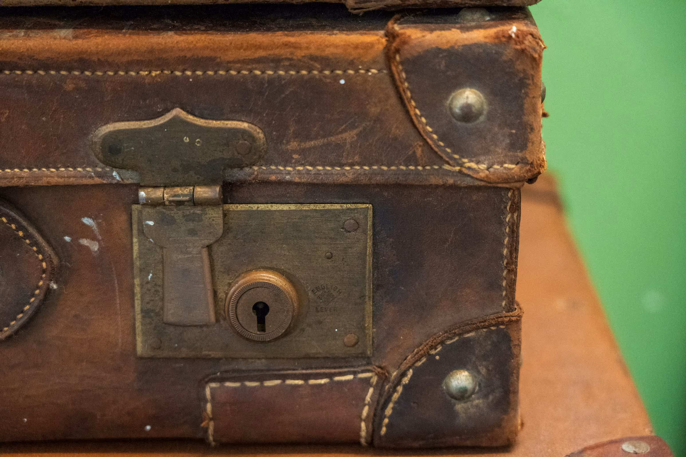 The lock and corners of an old leather suitcase