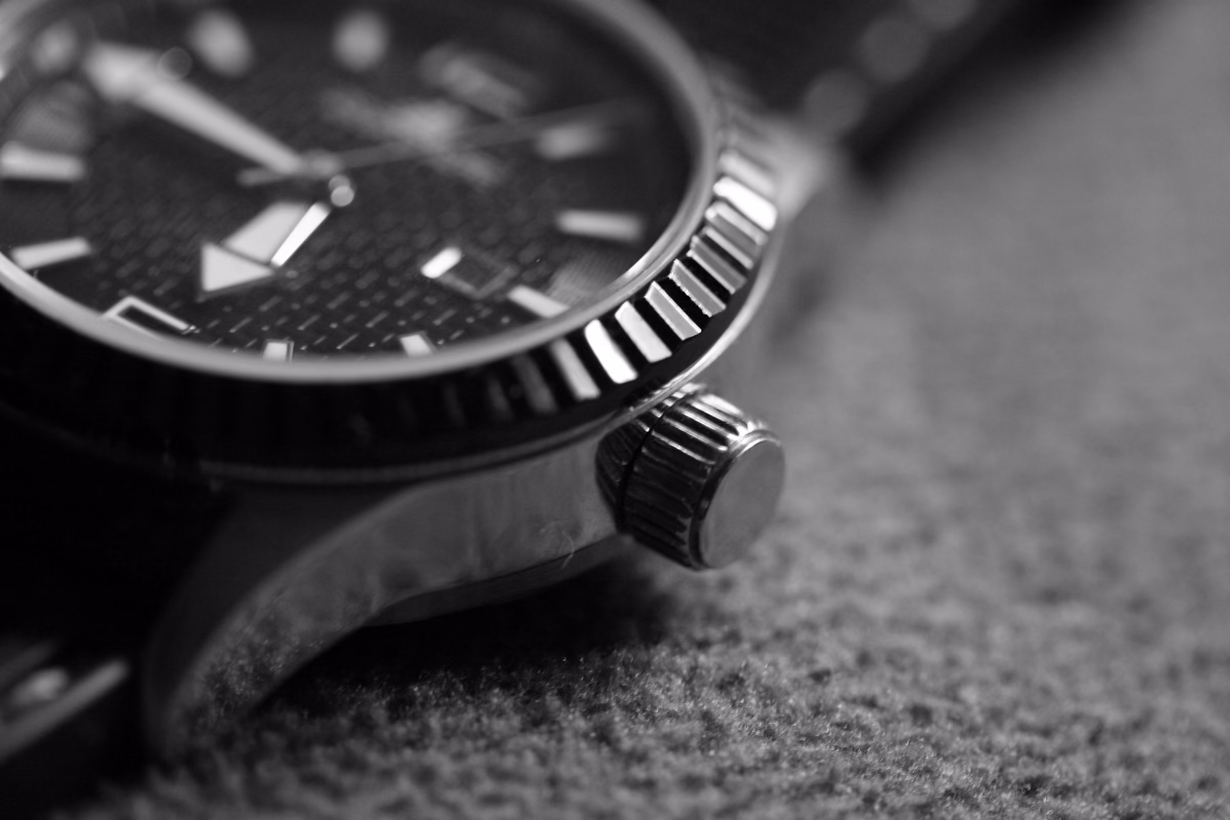 The bezel and crown of a dive watch, close up