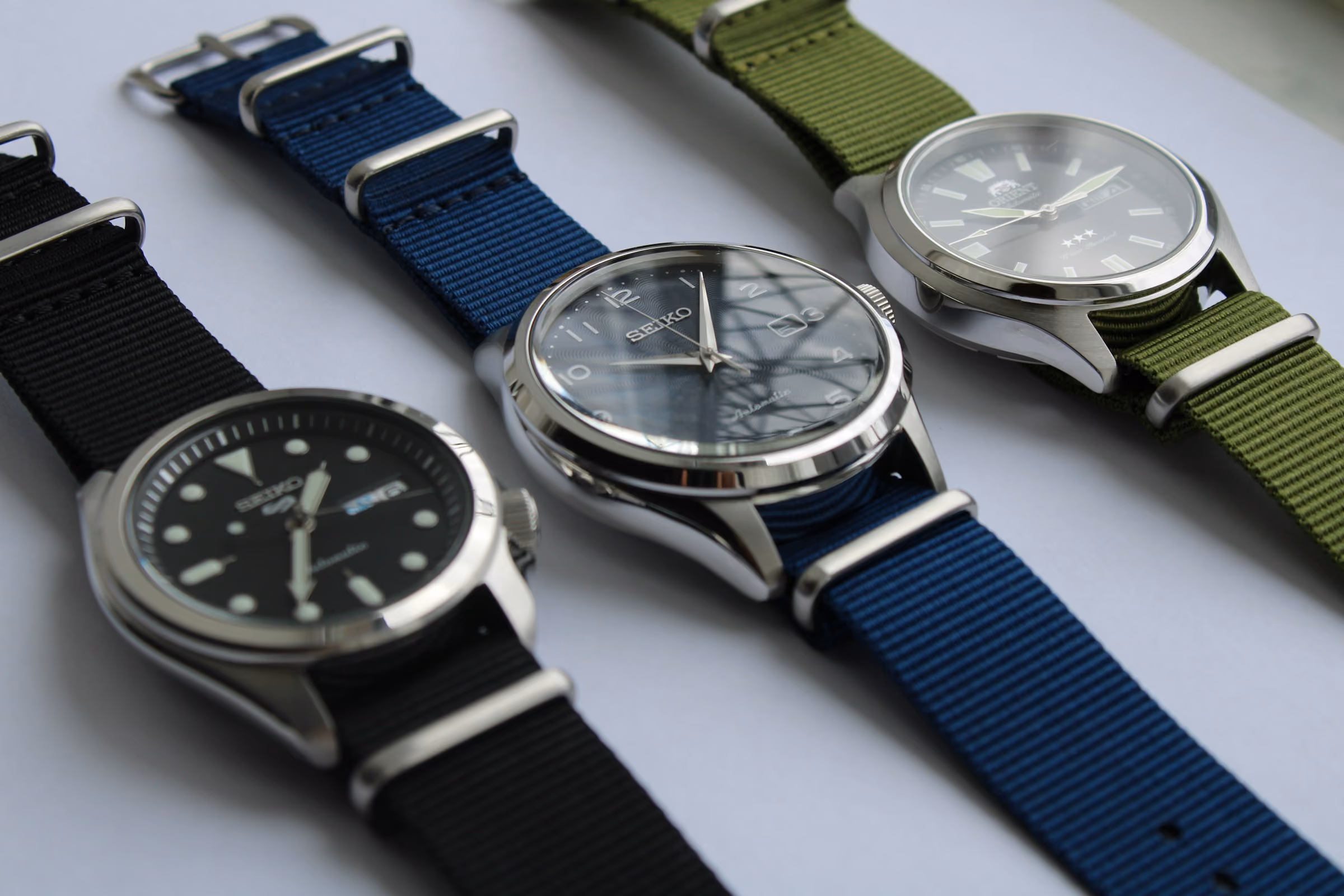 Three watches on fabric straps
