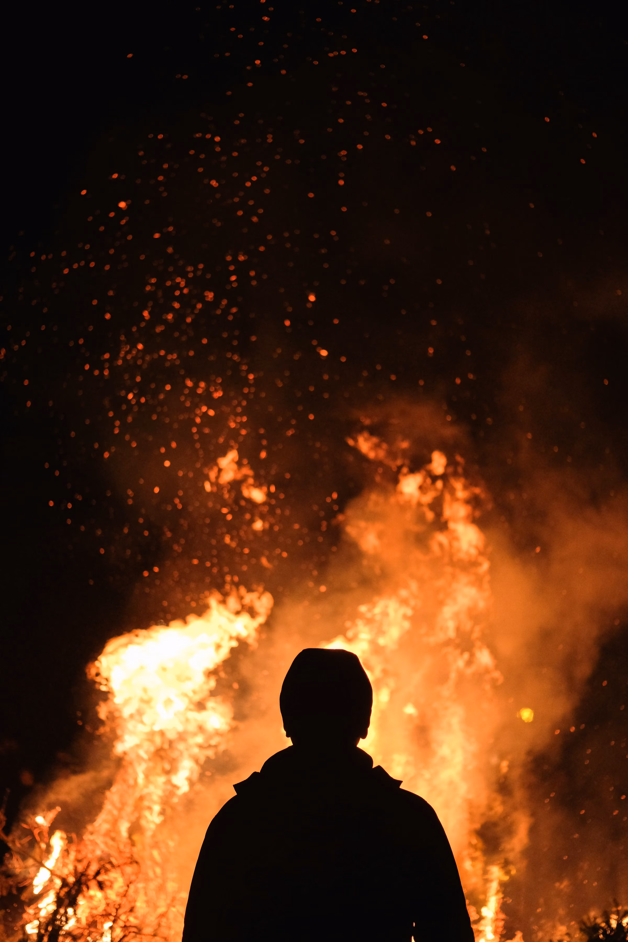A figure silhouetted against a fire