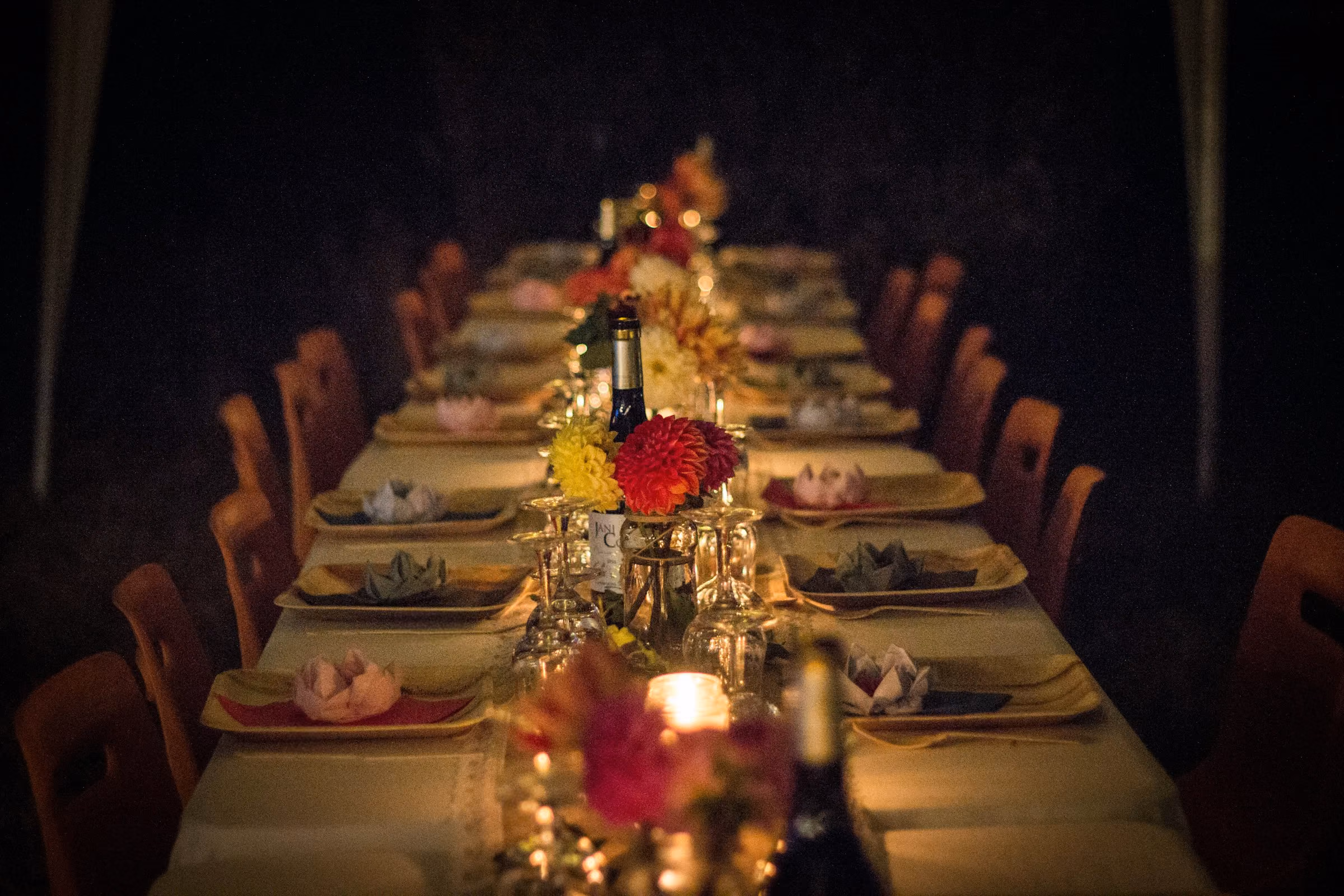A long table set with flowers and candles
