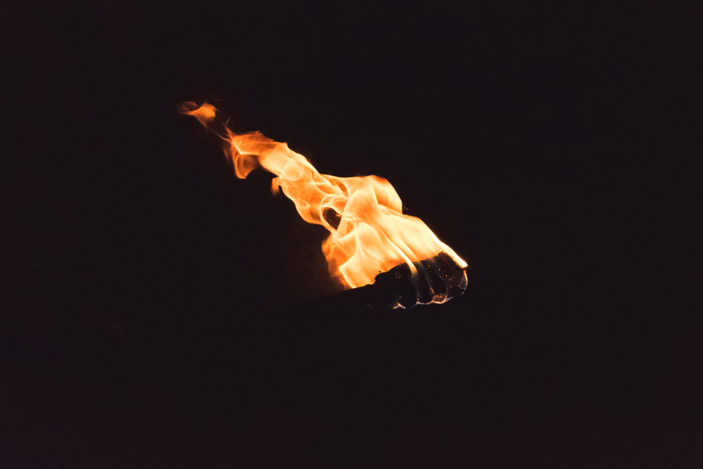 A flame against a dark sky