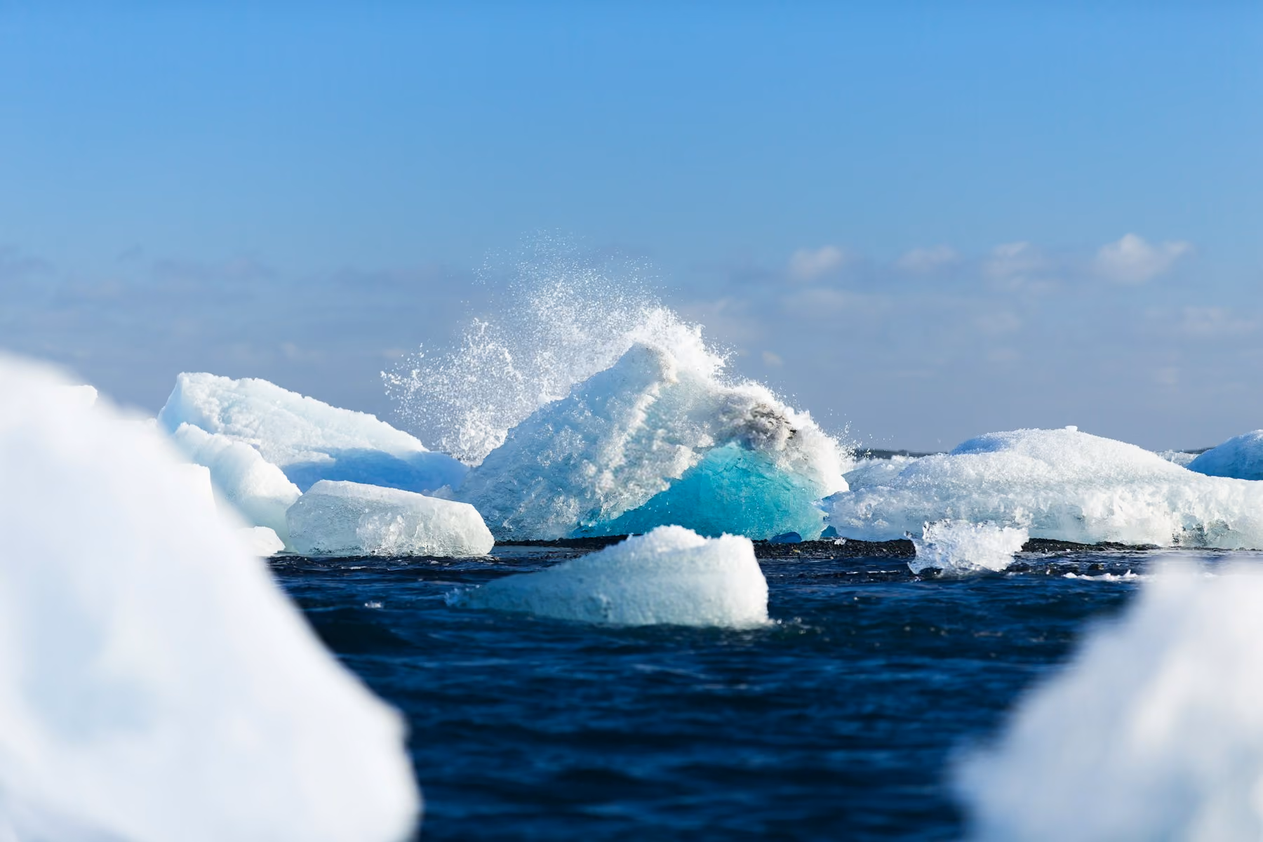 Glacier icebergs and spray on dark water in Vatnajökull, the best time to visit Iceland for ice
