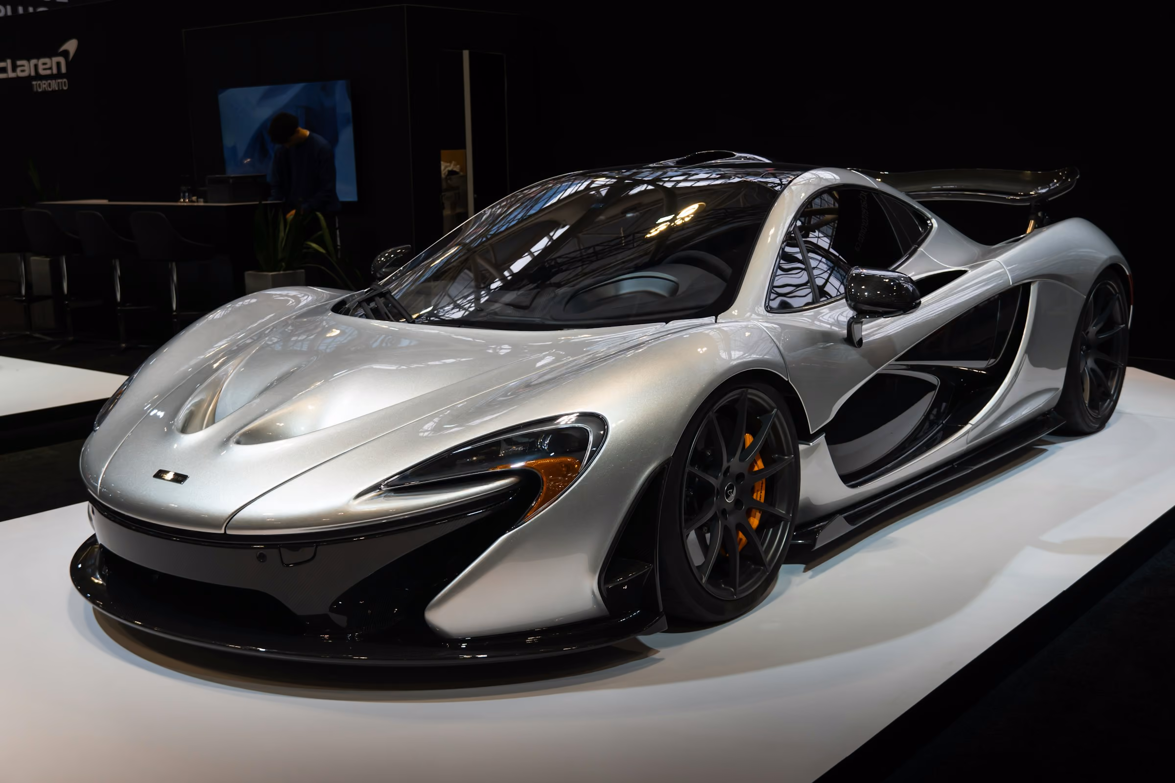 A silver McLaren P1 on display