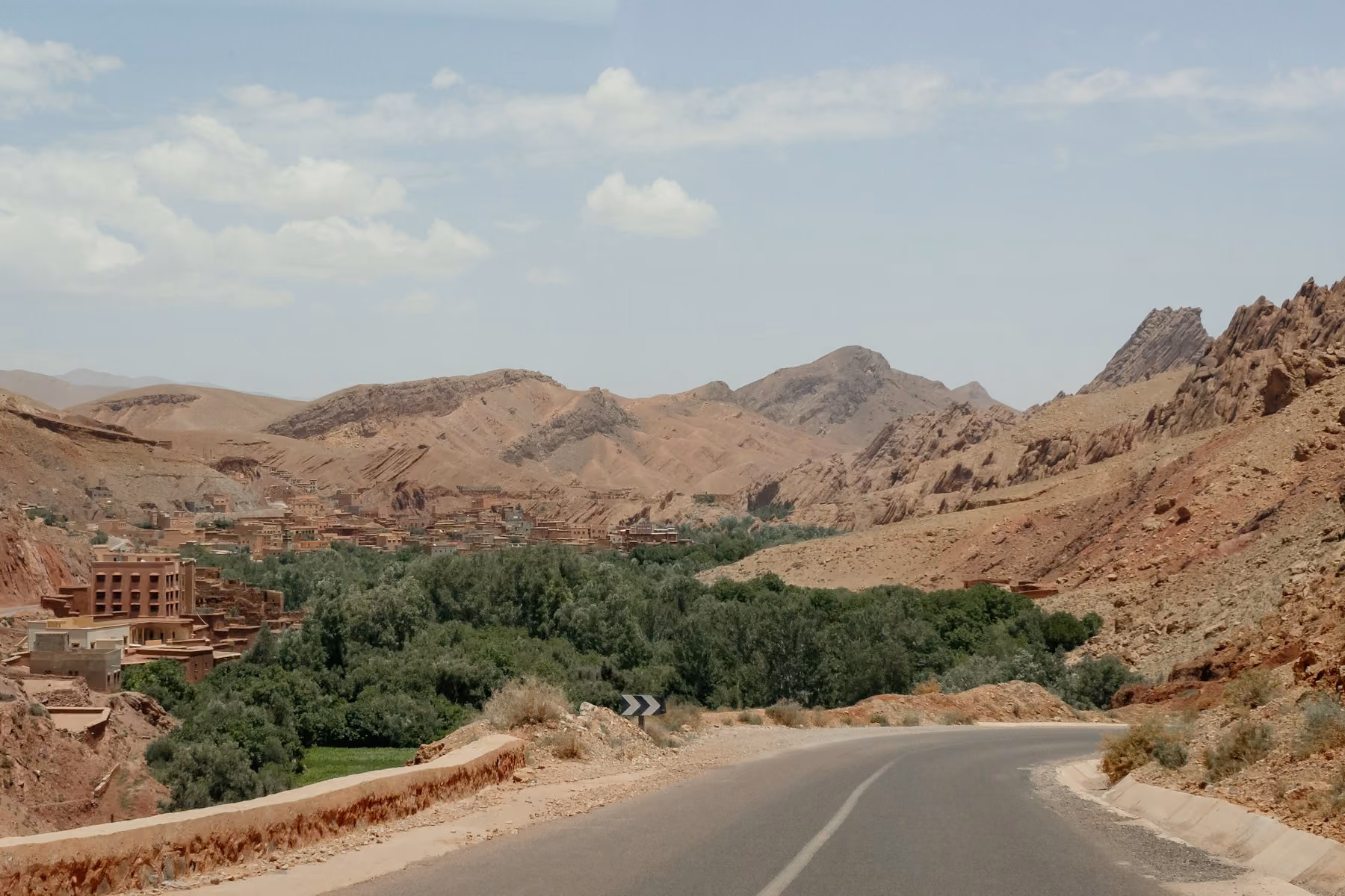 A road winding through the green oasis of the Dades valley near Boumalne Dades, Morocco