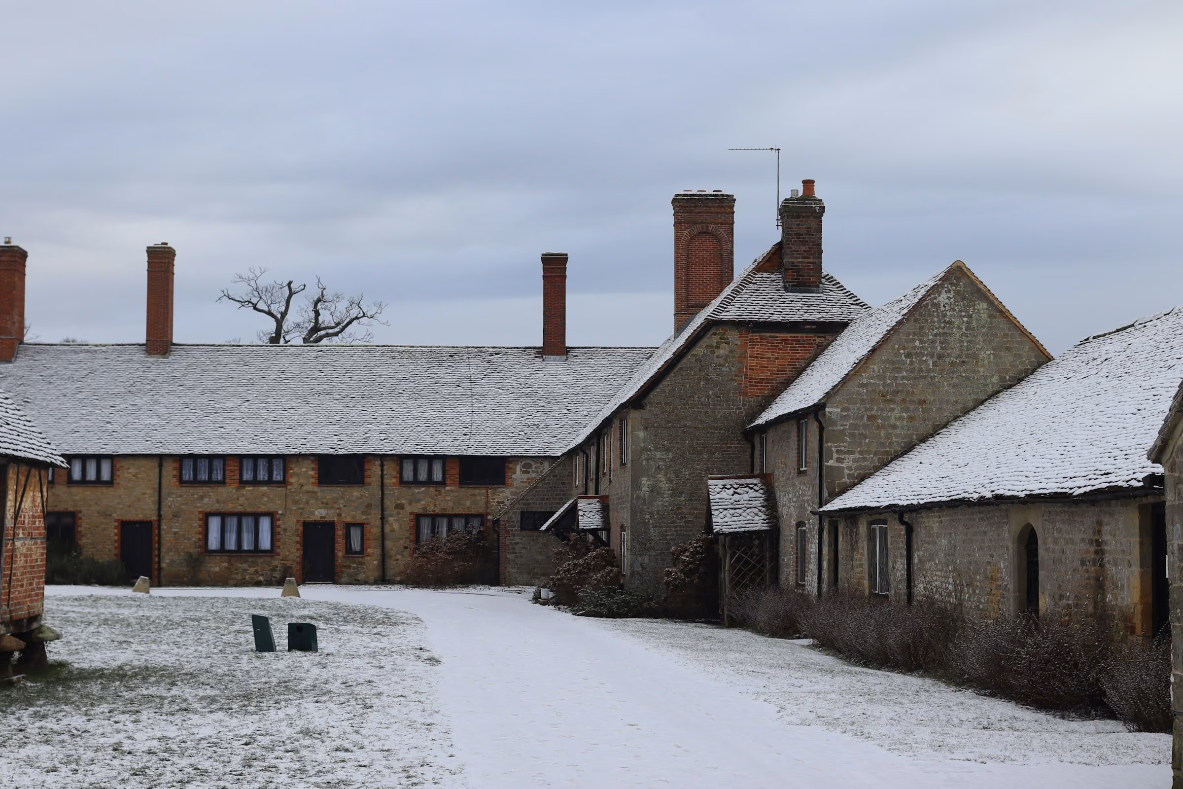 Stone Cotswold cottages under snow