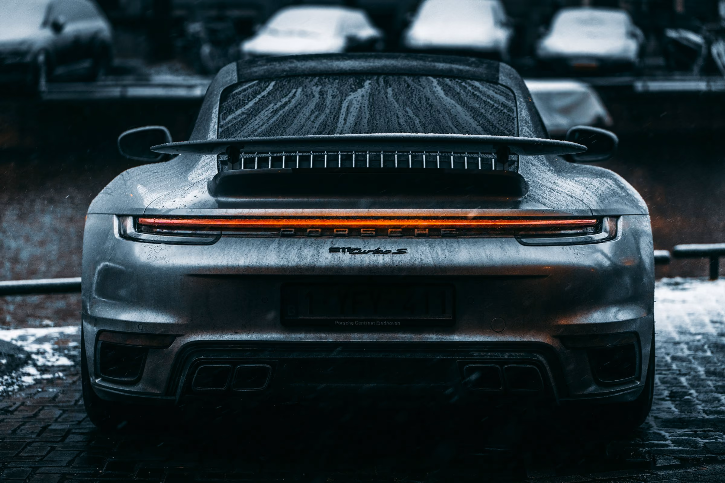 The rear of a Porsche 911 Turbo in the rain