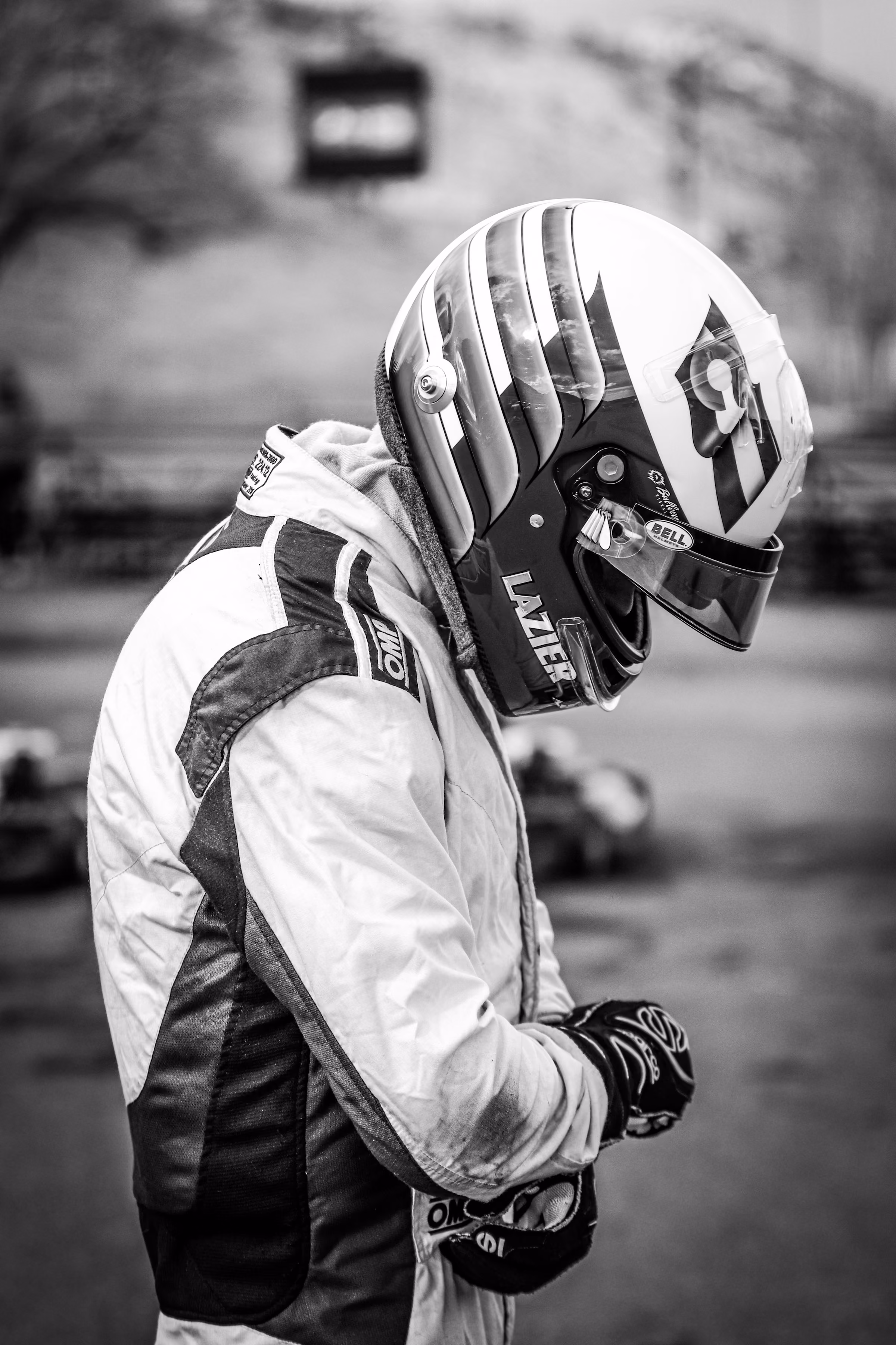 A racing driver in helmet and race suit before a session