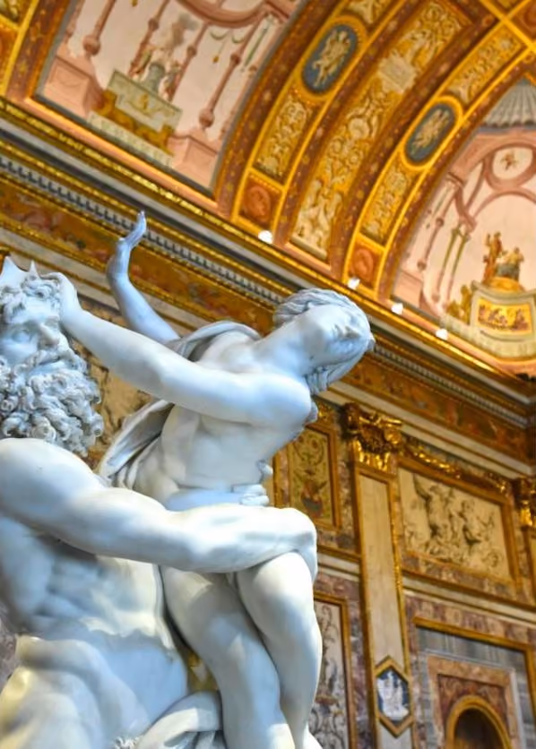 Bernini's marble group under the gilded ceiling of the Galleria Borghese