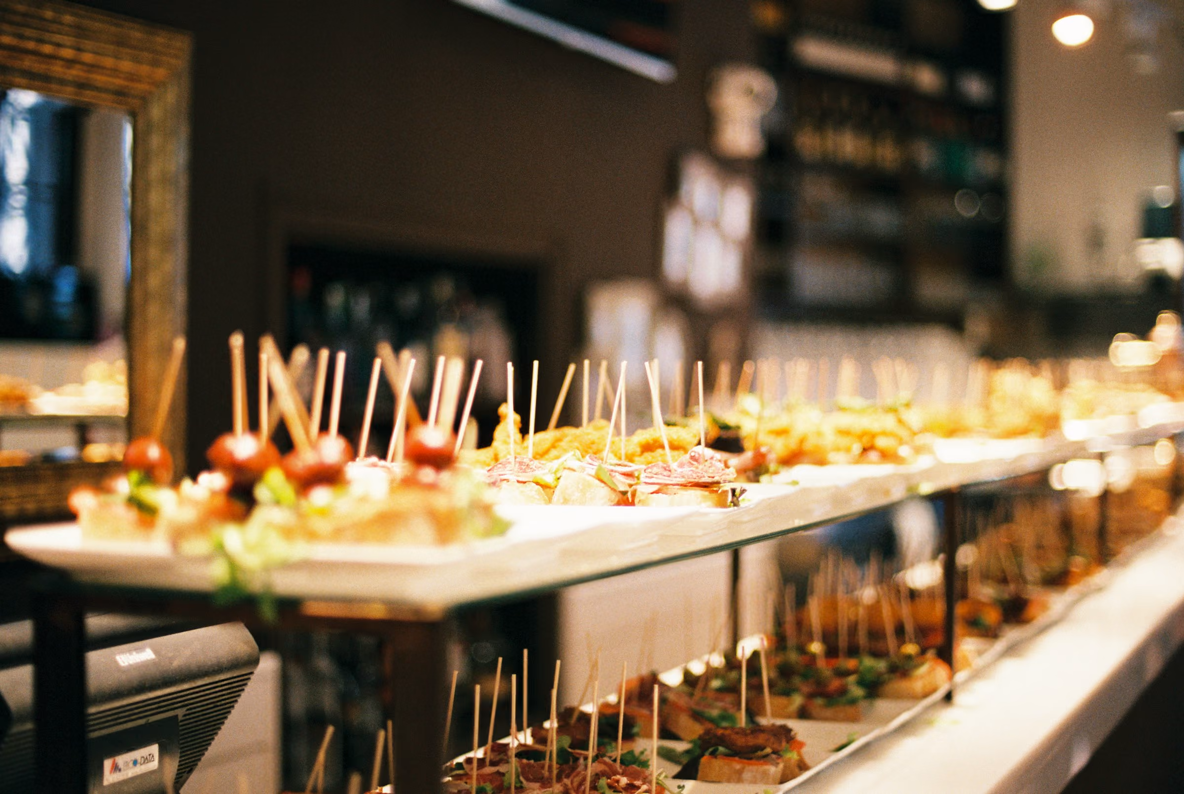 A bar counter lined with pintxos in San Sebastián's old town
