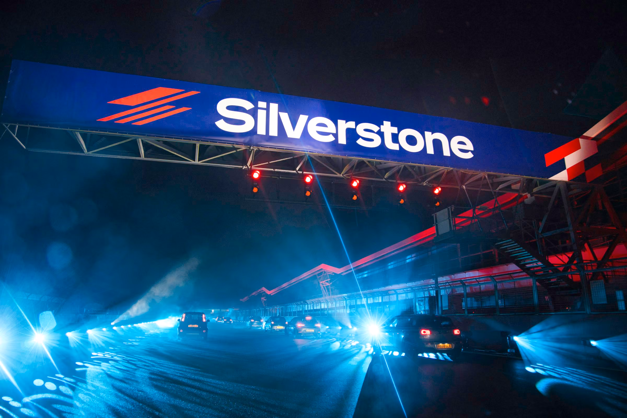 The lit Silverstone sign above the circuit entrance at night