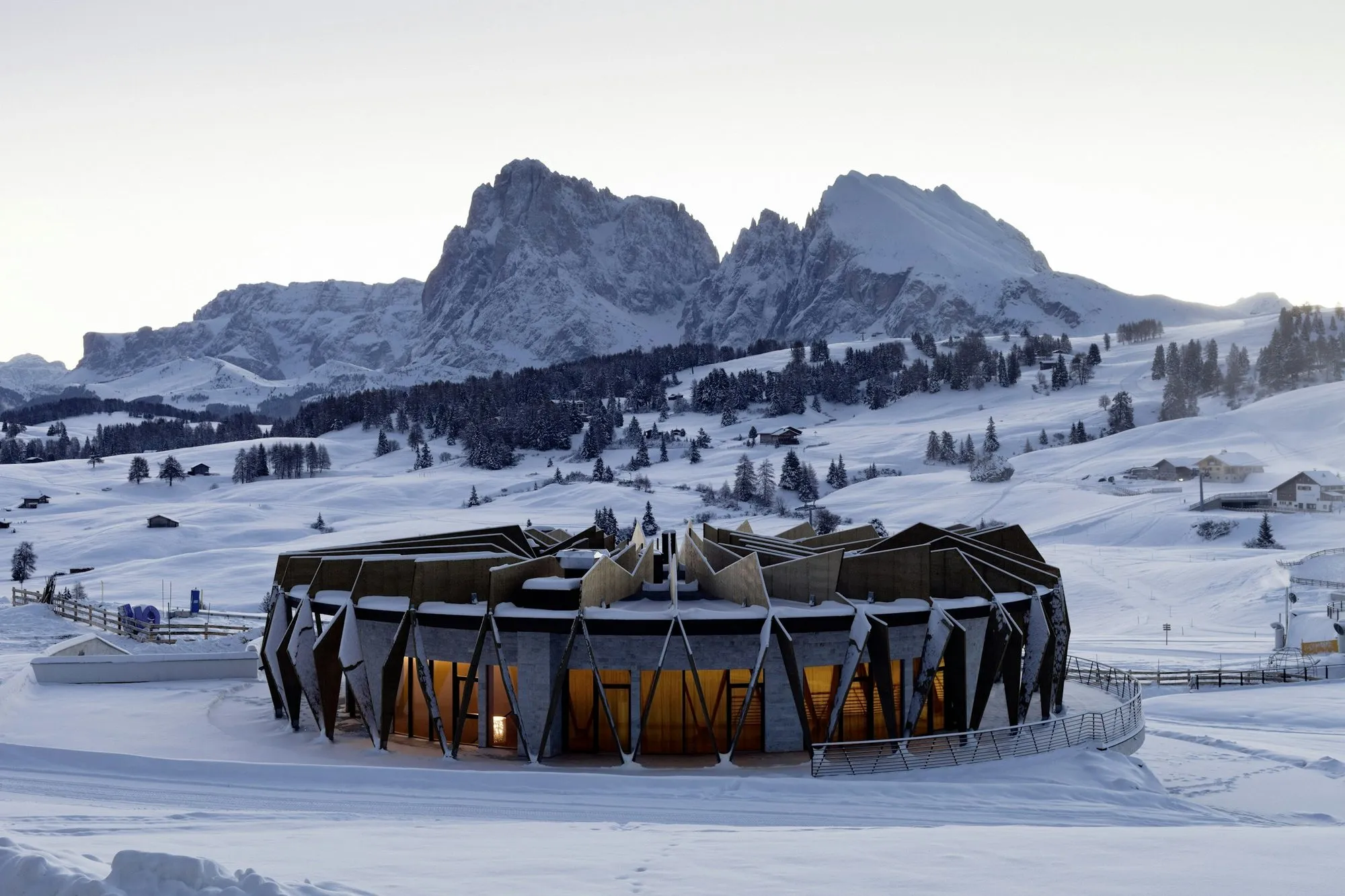 The Alpina Chalet in winter, with the Sassolungo and Sassopiatto behind