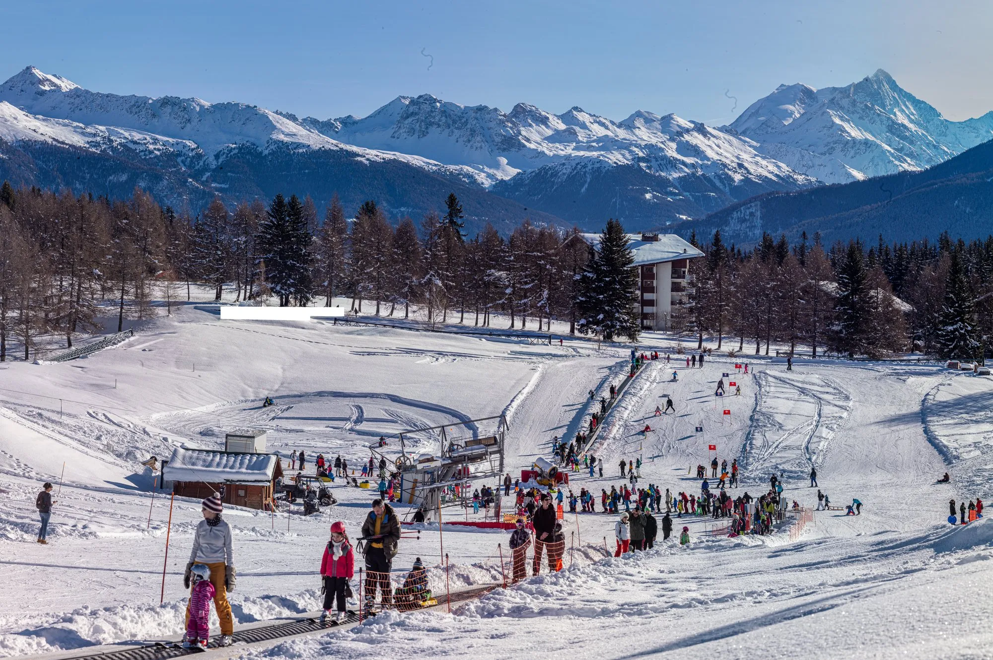 The slopes at Crans-Montana in winter, with the Valais Alps behind