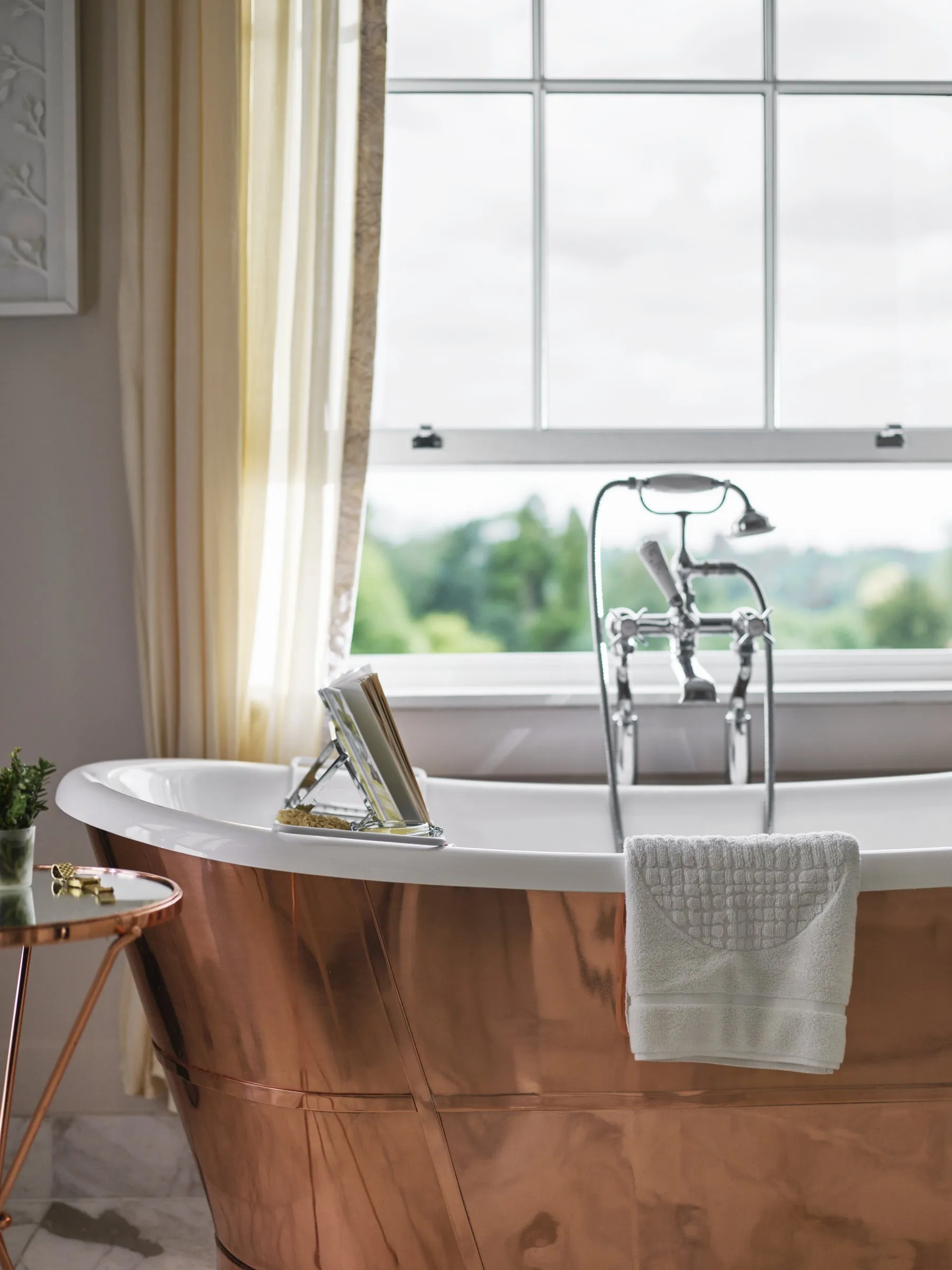 A copper bath by a window in the Arbuthnot suite