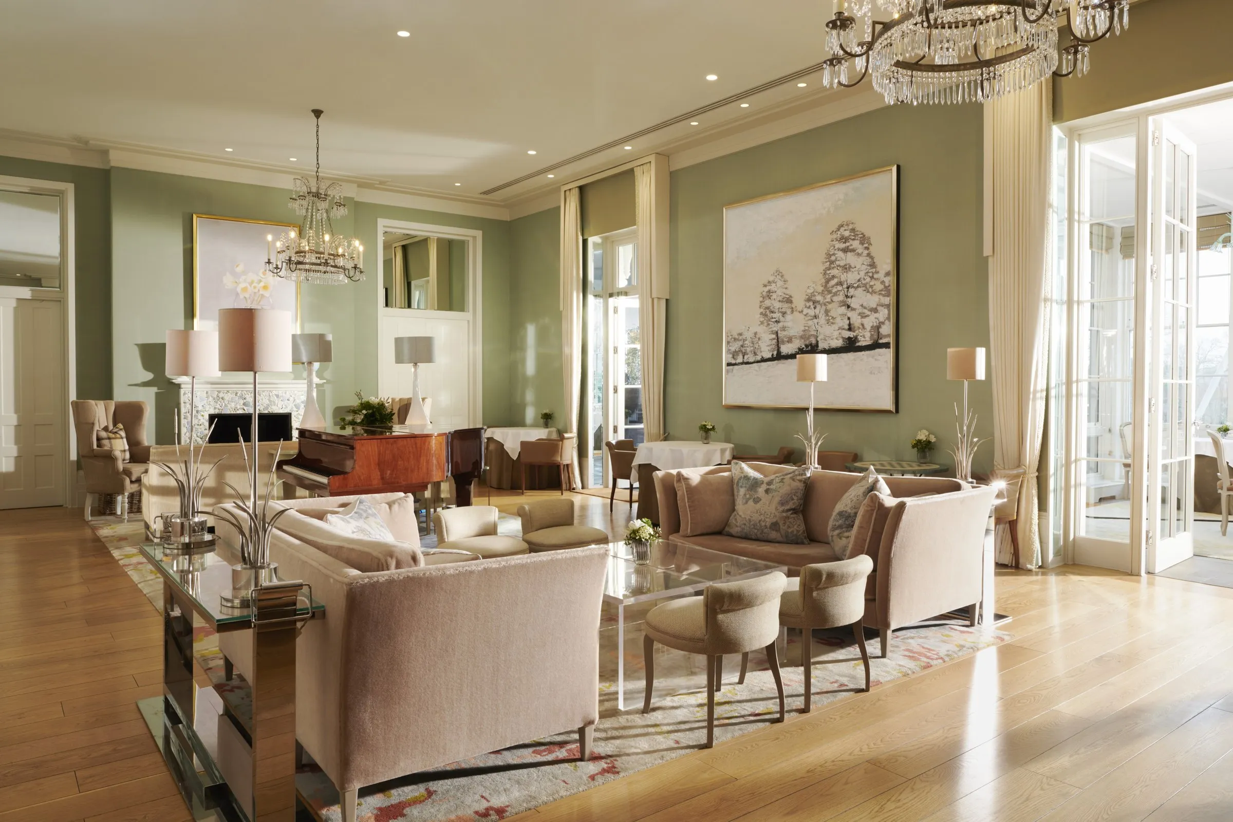 The Drawing Room, with sofas, chandeliers and garden doors