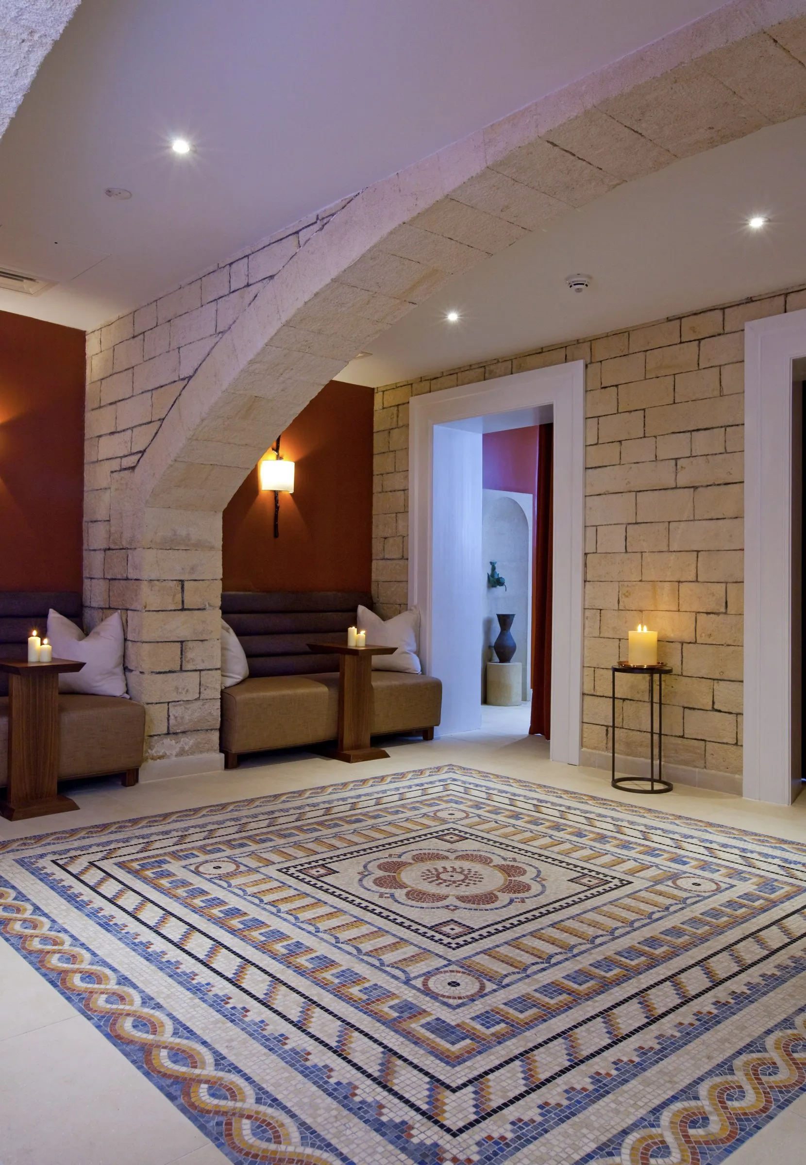 A relaxation area with a mosaic floor and stone walls