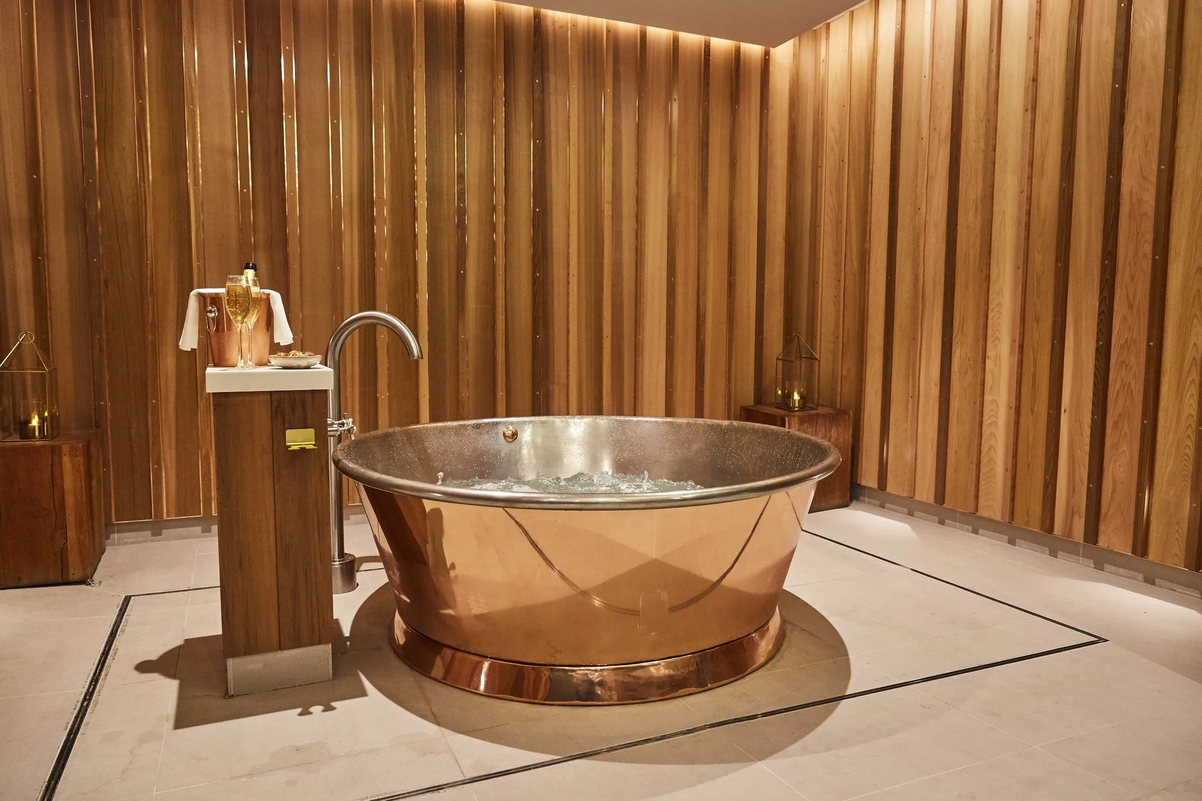 A copper bath in a timber-lined spa room