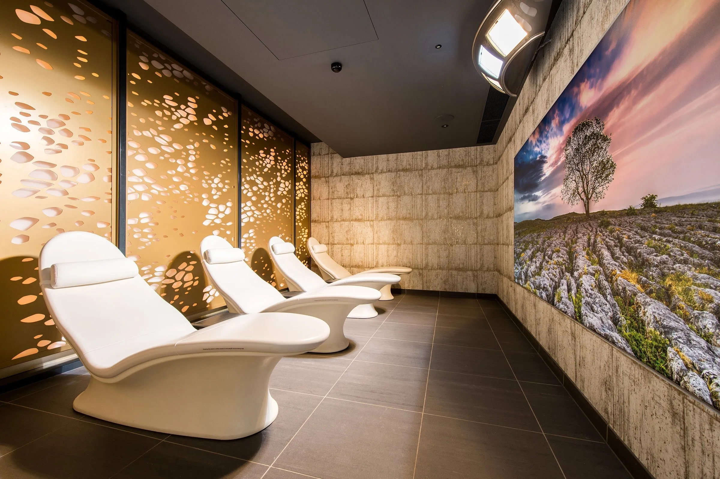 White relaxation loungers in a softly lit room