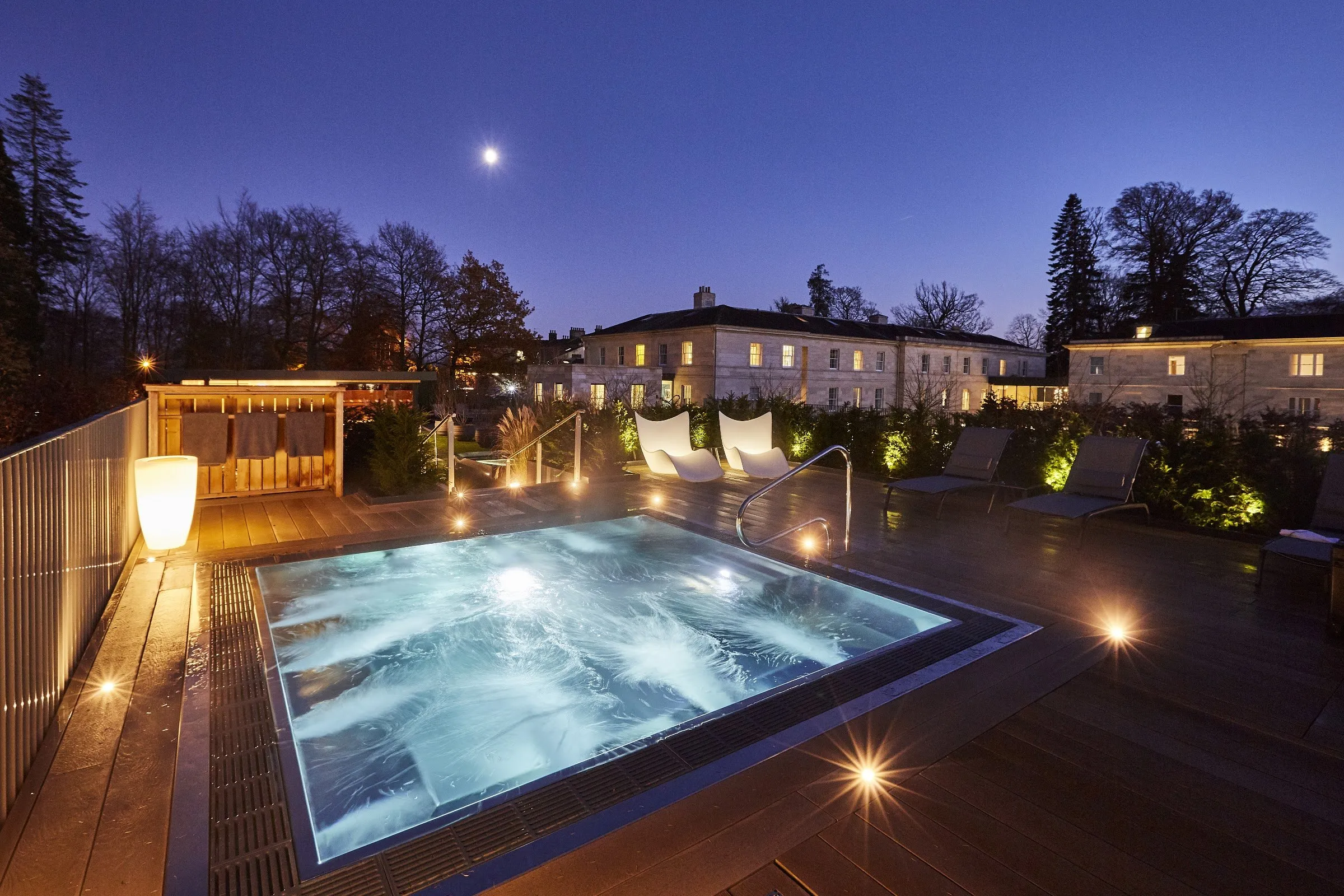 Rudding Park's rooftop hydrotherapy pool lit up at dusk, one of the best spa breaks in the UK