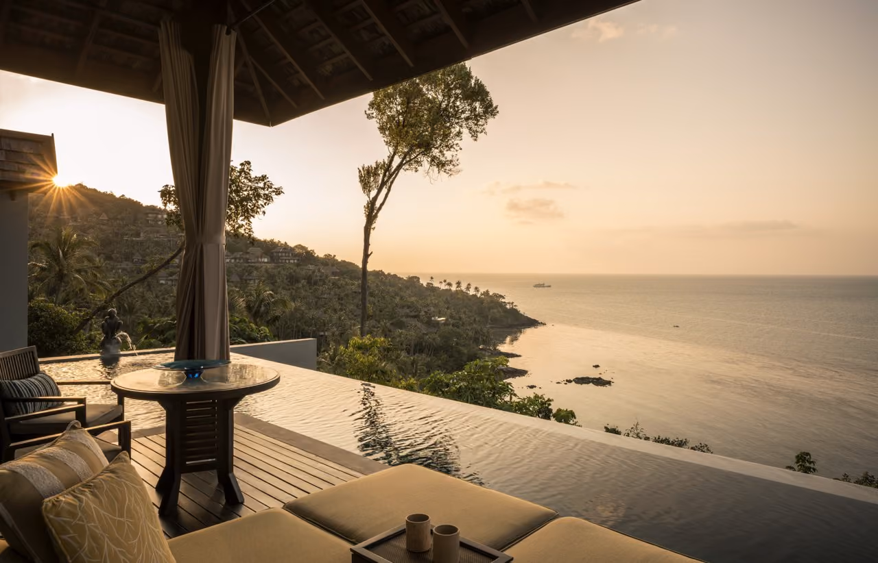 A villa sala and infinity pool above the sea at sunset at Four Seasons Resort Koh Samui