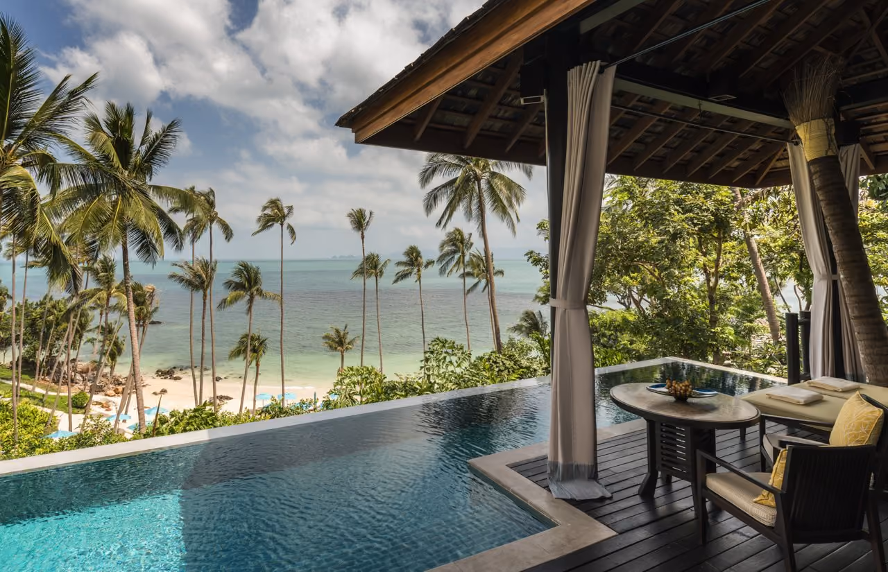 A villa deck with a private infinity pool at Four Seasons Resort Koh Samui, the last stop on the trip from Chiang Mai to Koh Samui, looking down through palms to the beach