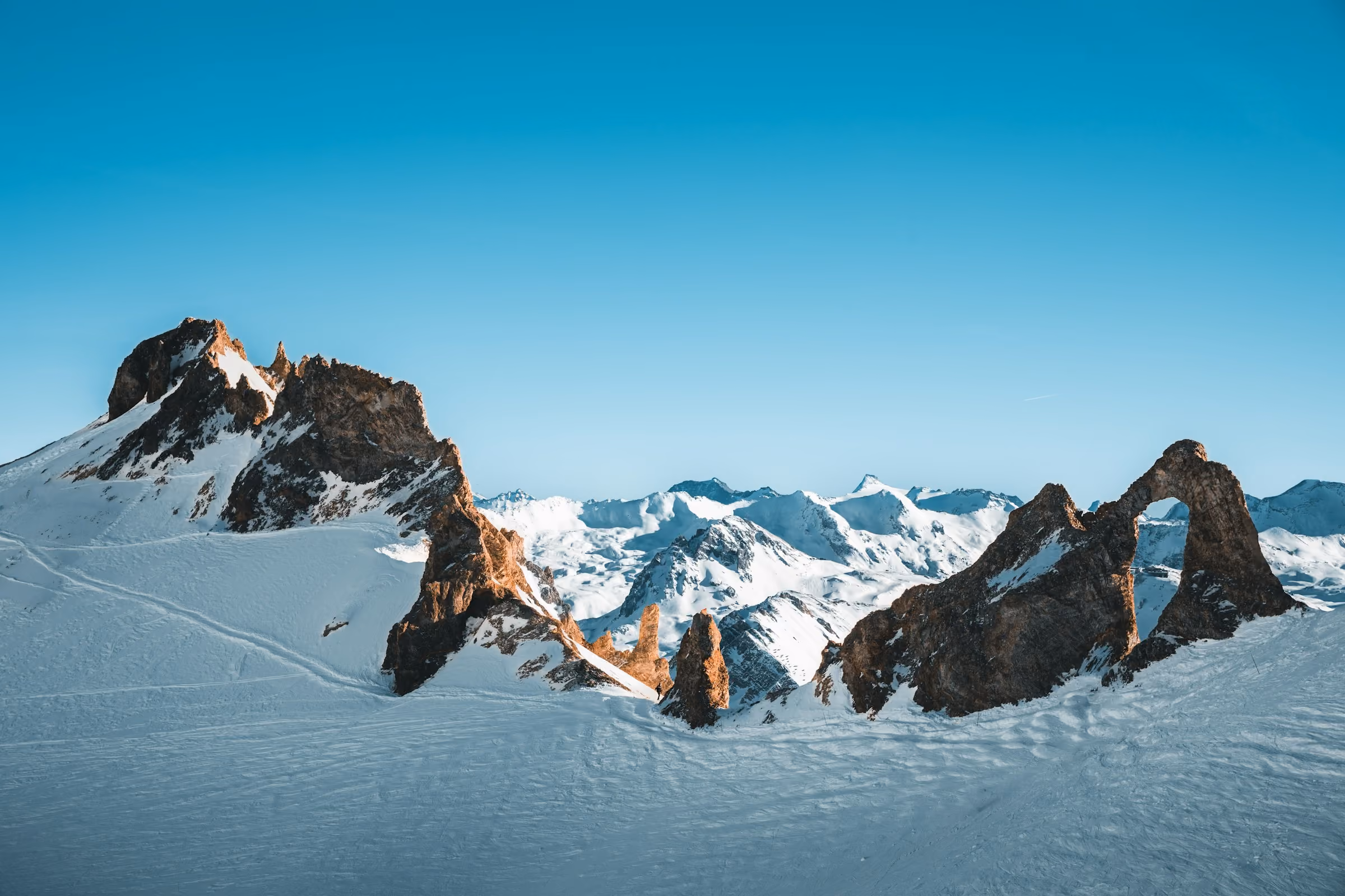 Jagged snowy peaks above Val d'Isère under a clear blue sky