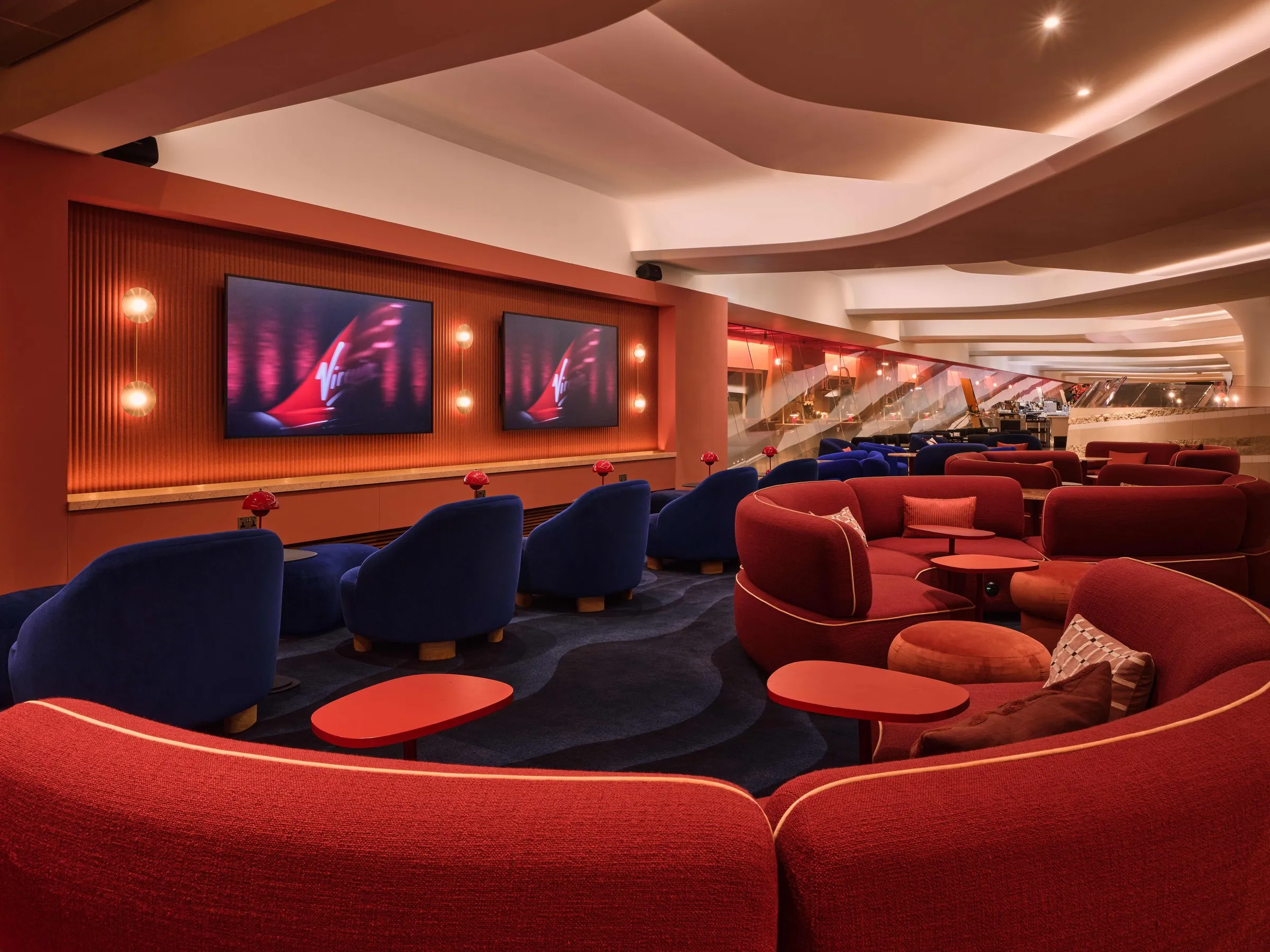 The Clubhouse cinema room with red and navy seating
