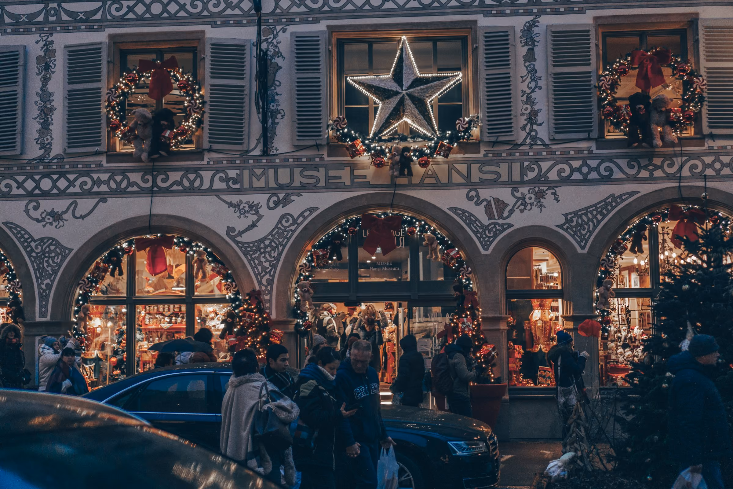 A shopfront decorated with wreaths and stars in Alsace