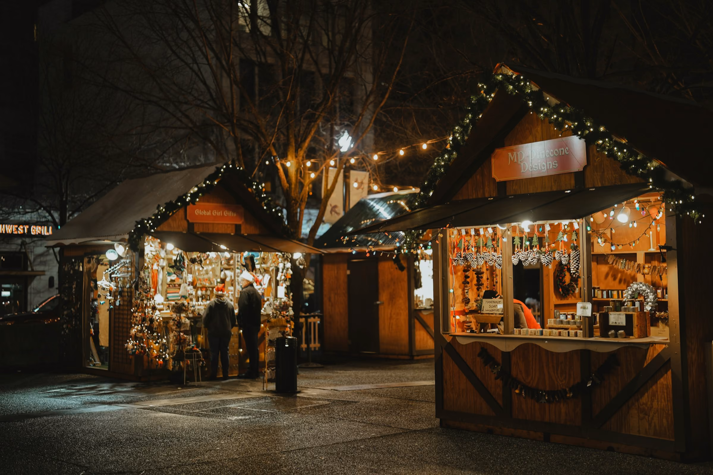 Wooden Christmas market chalets lit at night